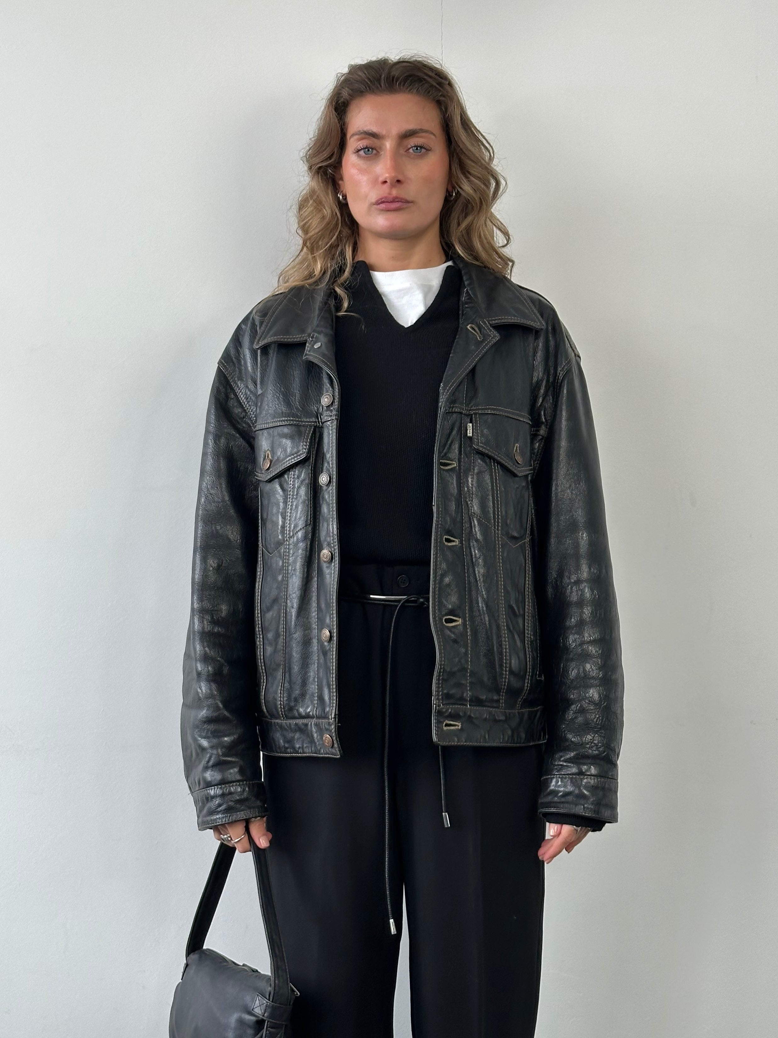Levi’s 1990s Type III leather trucker jacket in size L, featuring classic design with front pockets and button closure.