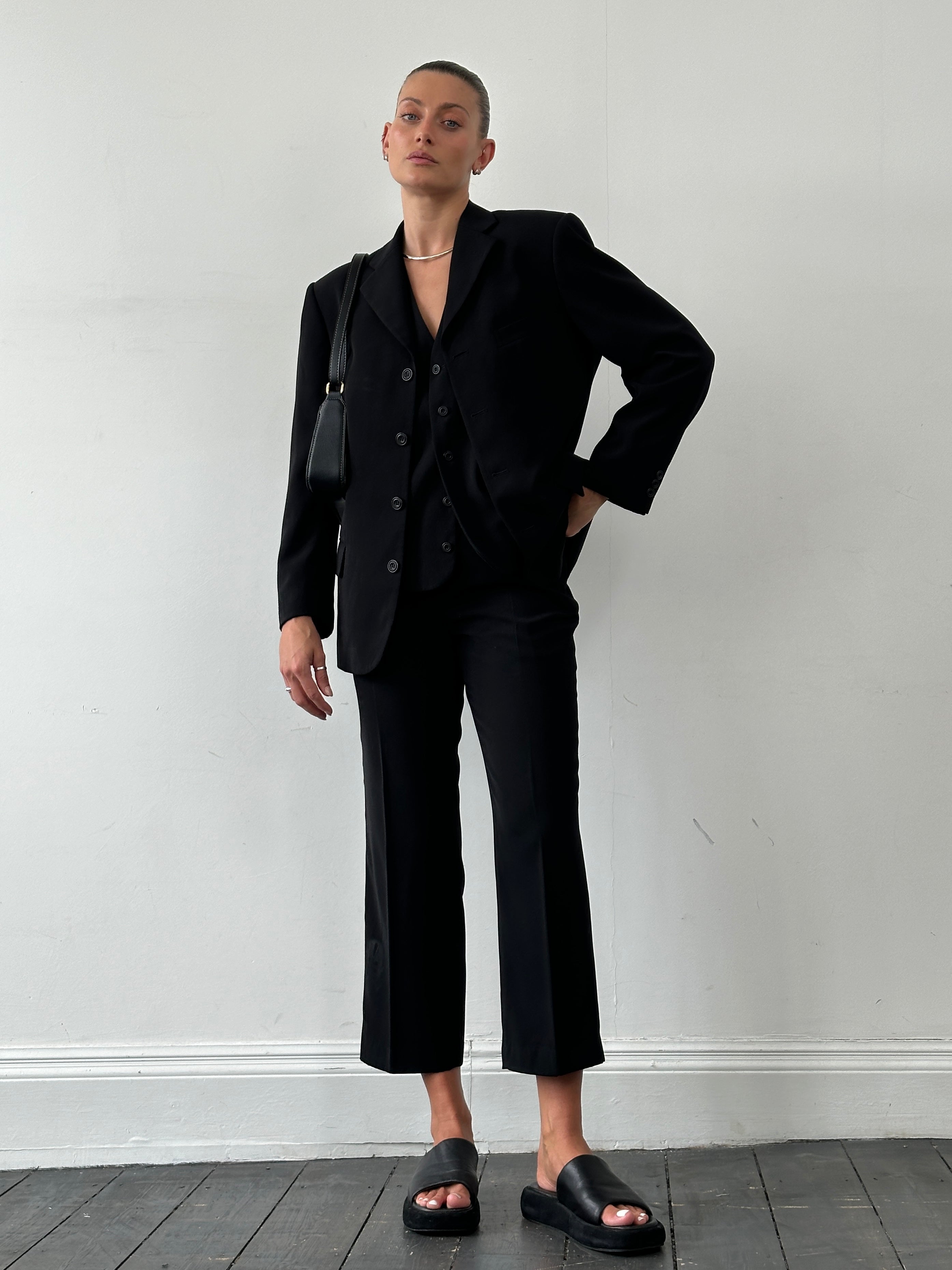 Vintage single-breasted three-piece suit in size 36R/W28, featuring classic tailoring and a timeless design.