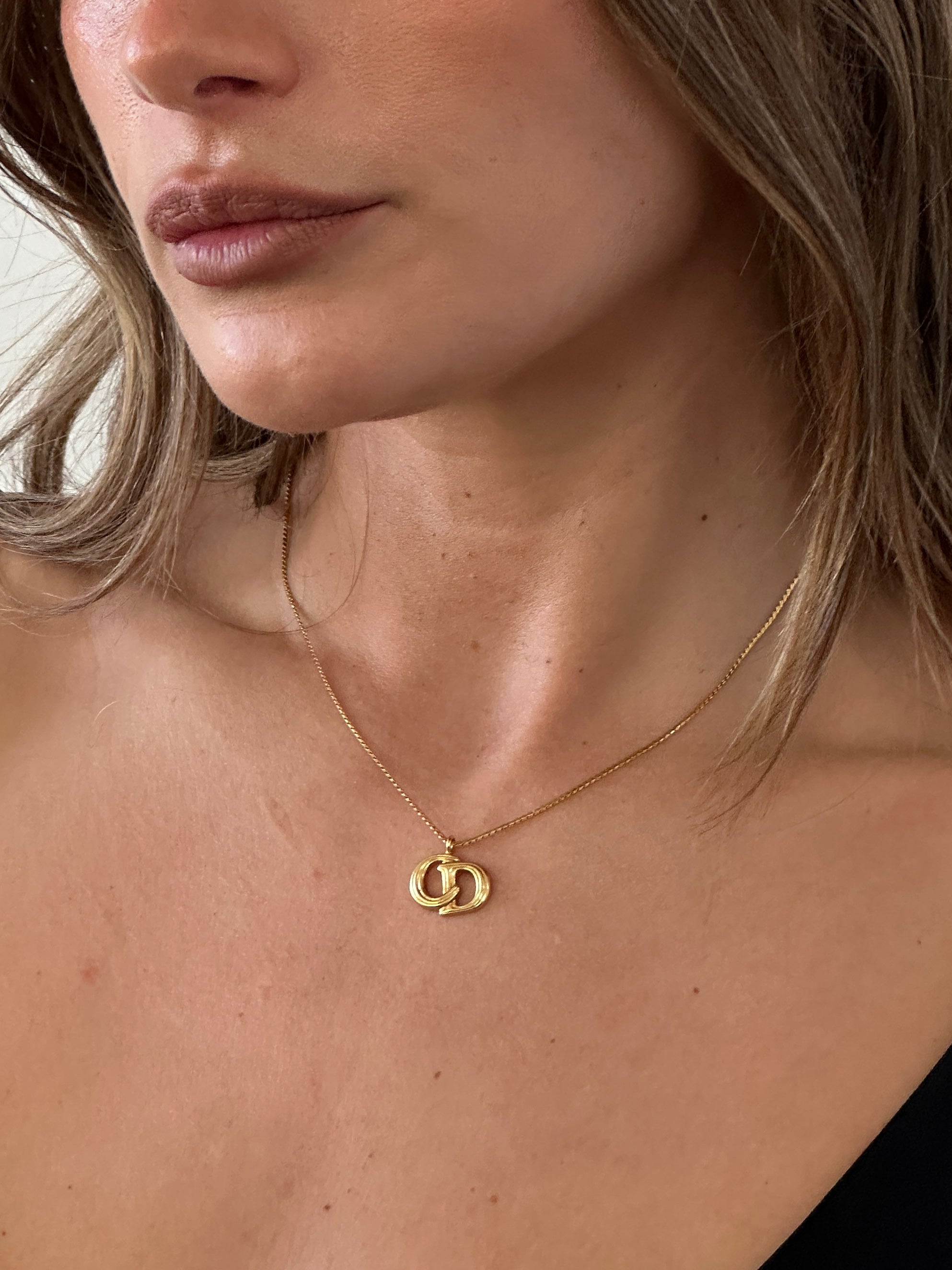 Christian Dior 16-inch gold plated logo pendant necklace, featuring a stylish and elegant jewelry design.