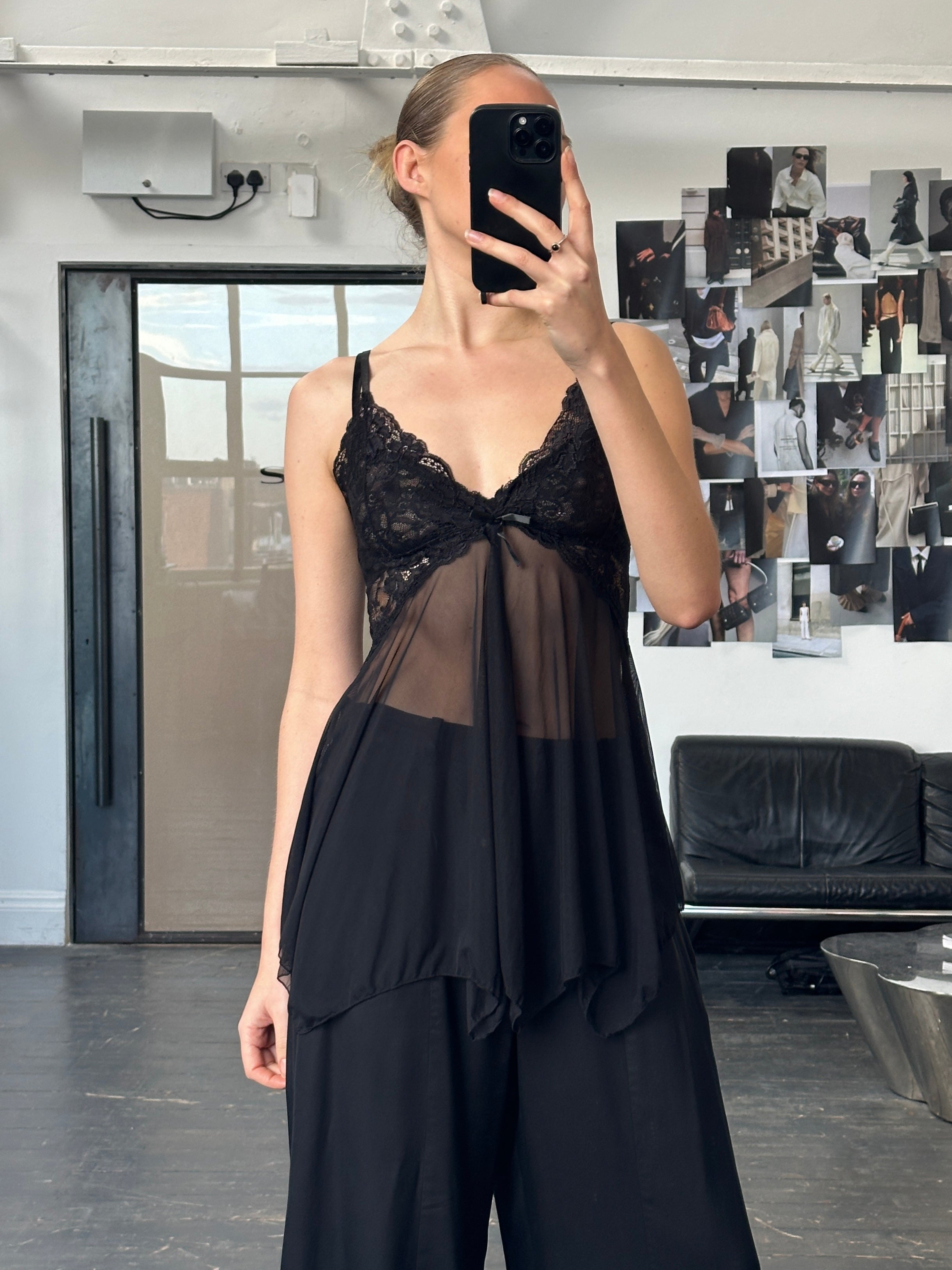 Vintage 1990s sheer lace mesh babydoll top, size S/M, featuring delicate lace and lightweight fabric, displayed on a hanger.