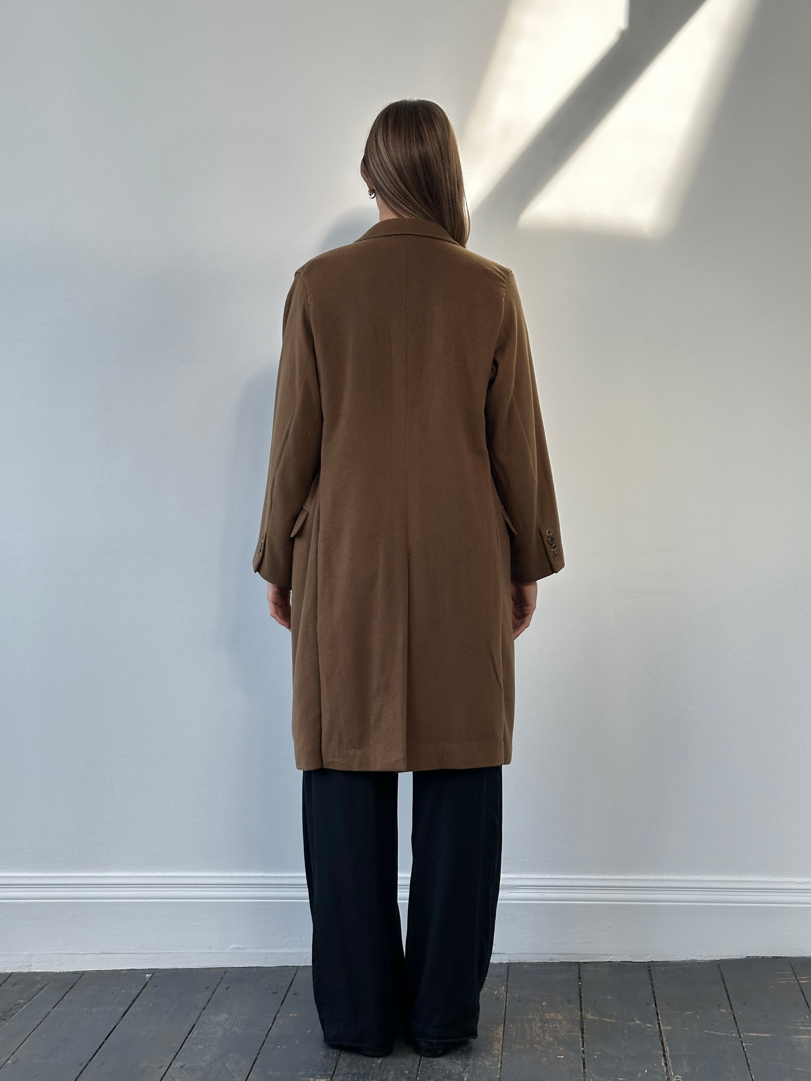 Vintage 1980s Italian pure cashmere coat in size S/M, featuring classic design and luxurious fabric, displayed on a hanger.