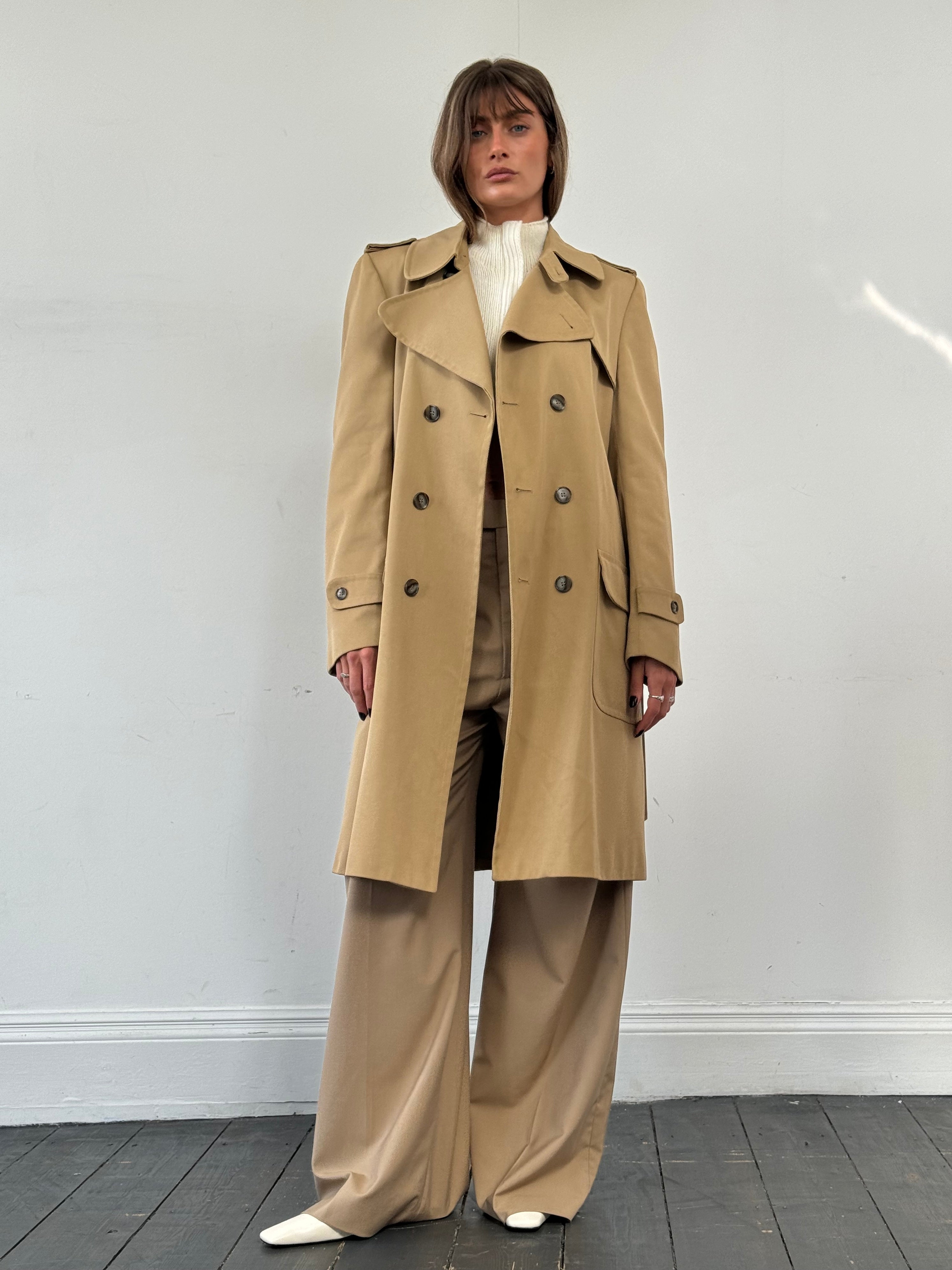 Vintage wool double-breasted trench coat in size large, classic style with wide lapels and belt, displayed on a hanger.