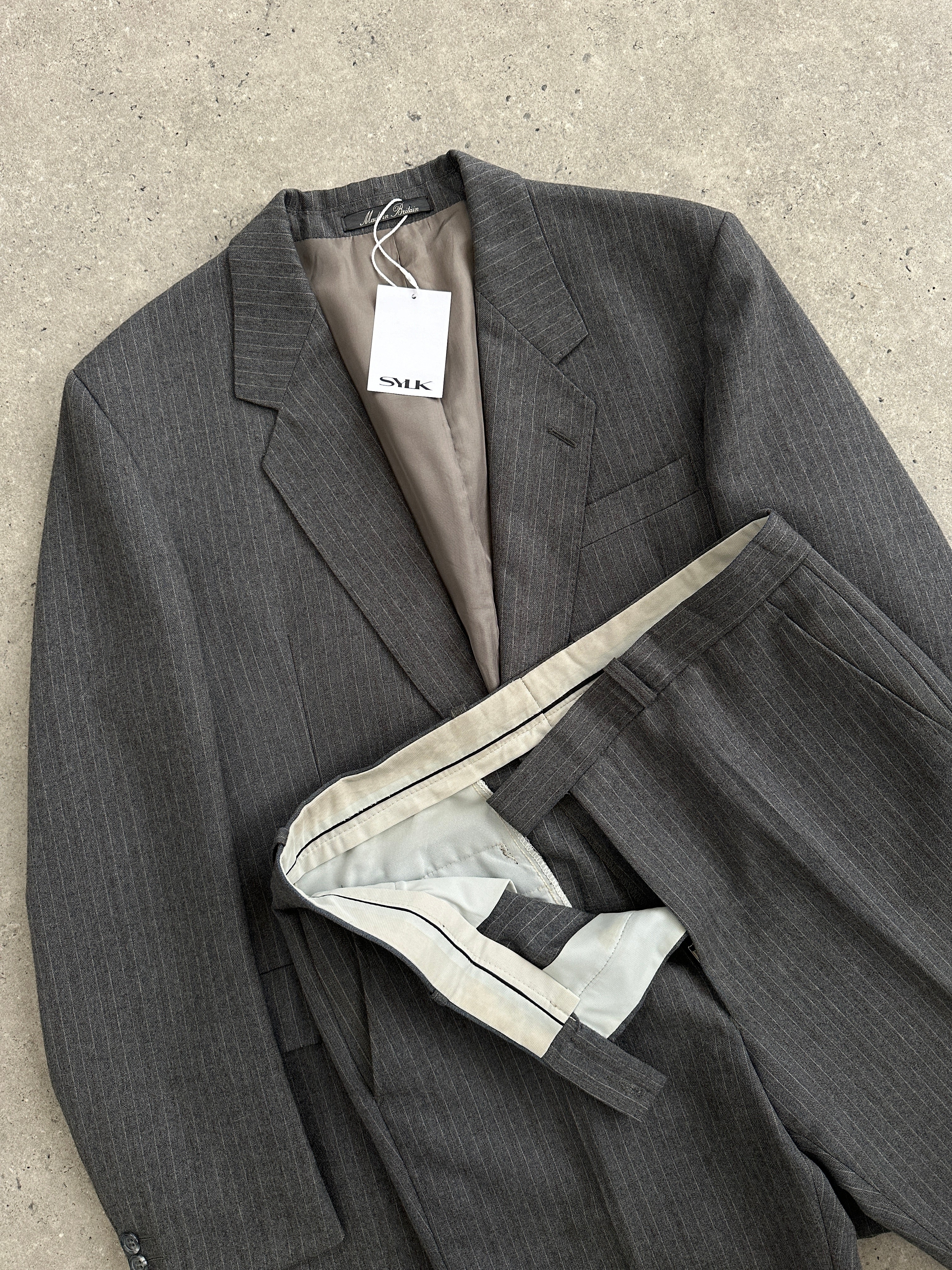 Vintage British pinstripe wool jumpsuit, single-breasted suit in size 42R/W32, featuring classic tailoring and vintage style.