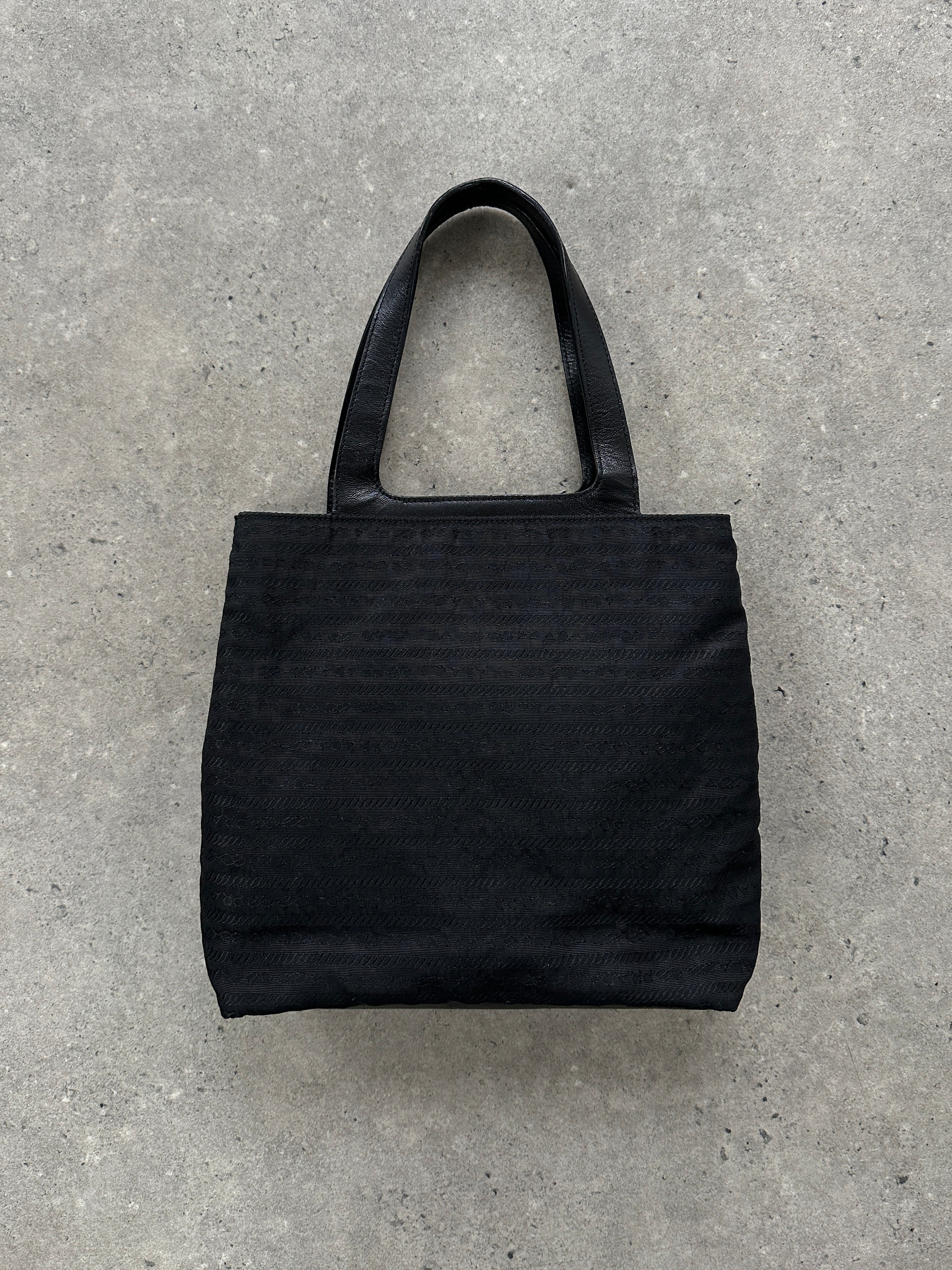 Prada 1990s Tessuto Monogram handbag with leather accents, featuring the signature Prada logo and classic design.