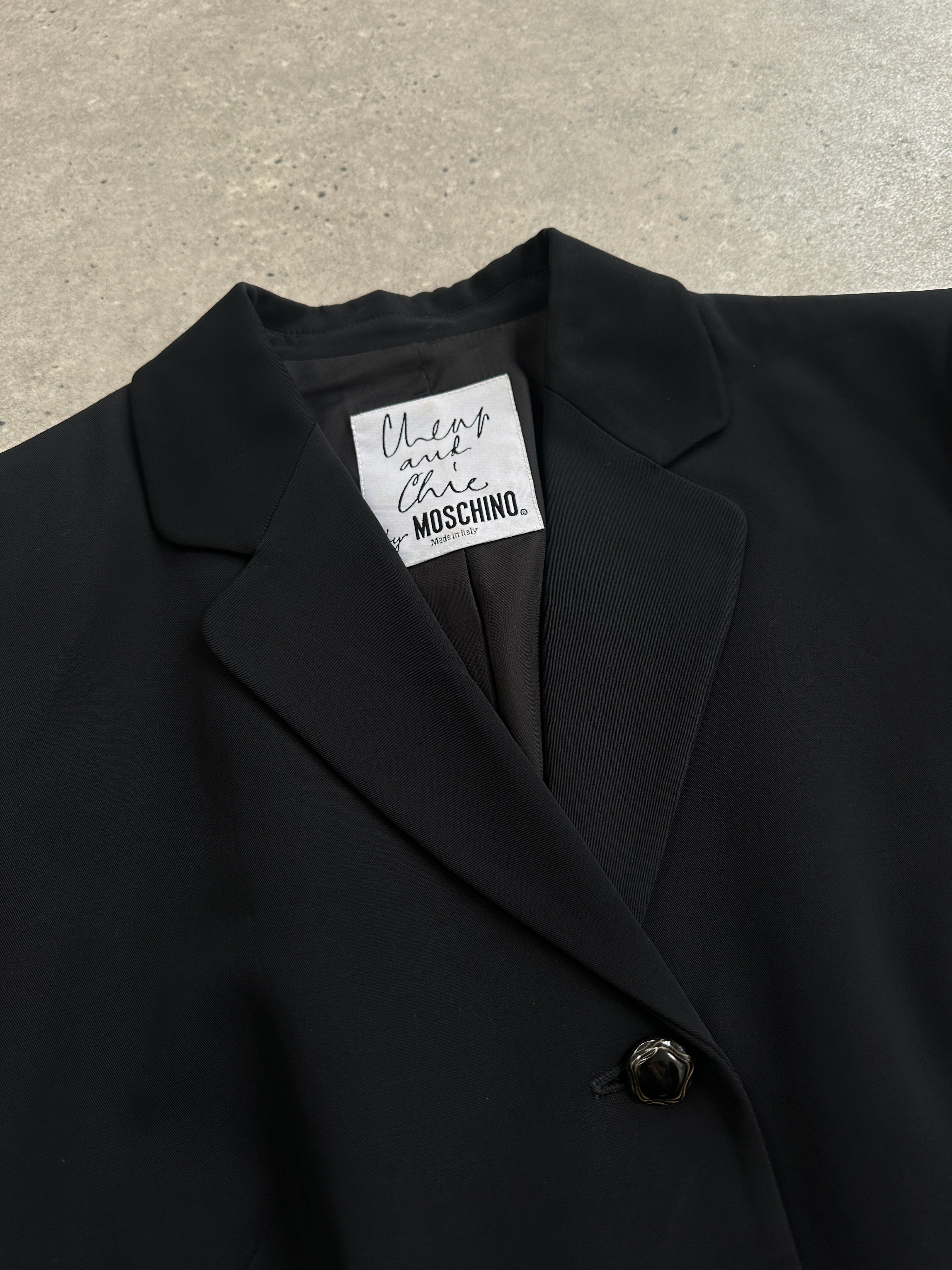 Moschino Cheap & Chic 90s single-breasted blazer in black, tailored fit, with lapel collar and button closure, stylish and classic.