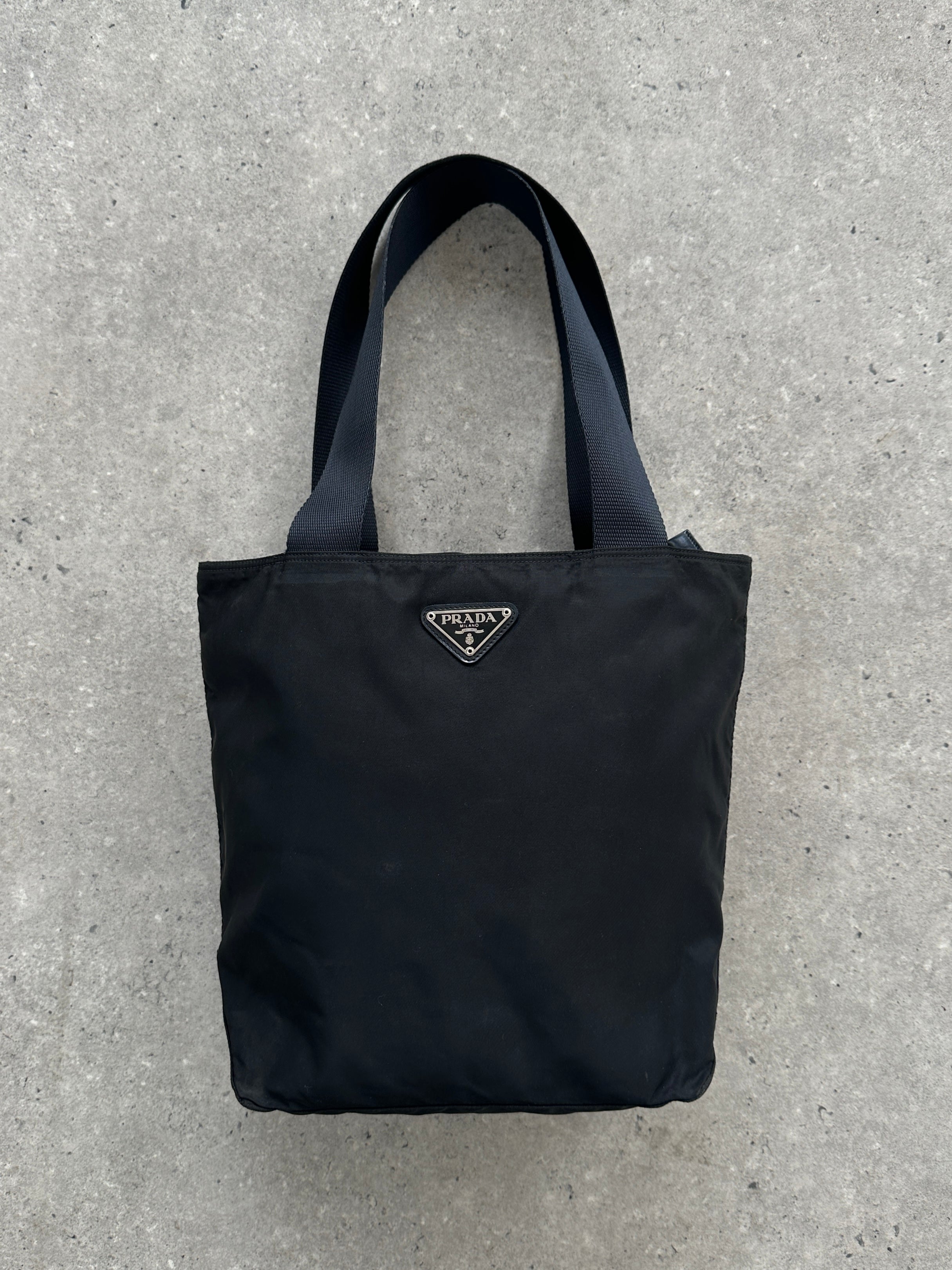 Prada 1997 nylon shoulder bag with adjustable strap and sleek design, featuring the iconic Prada logo on the front.