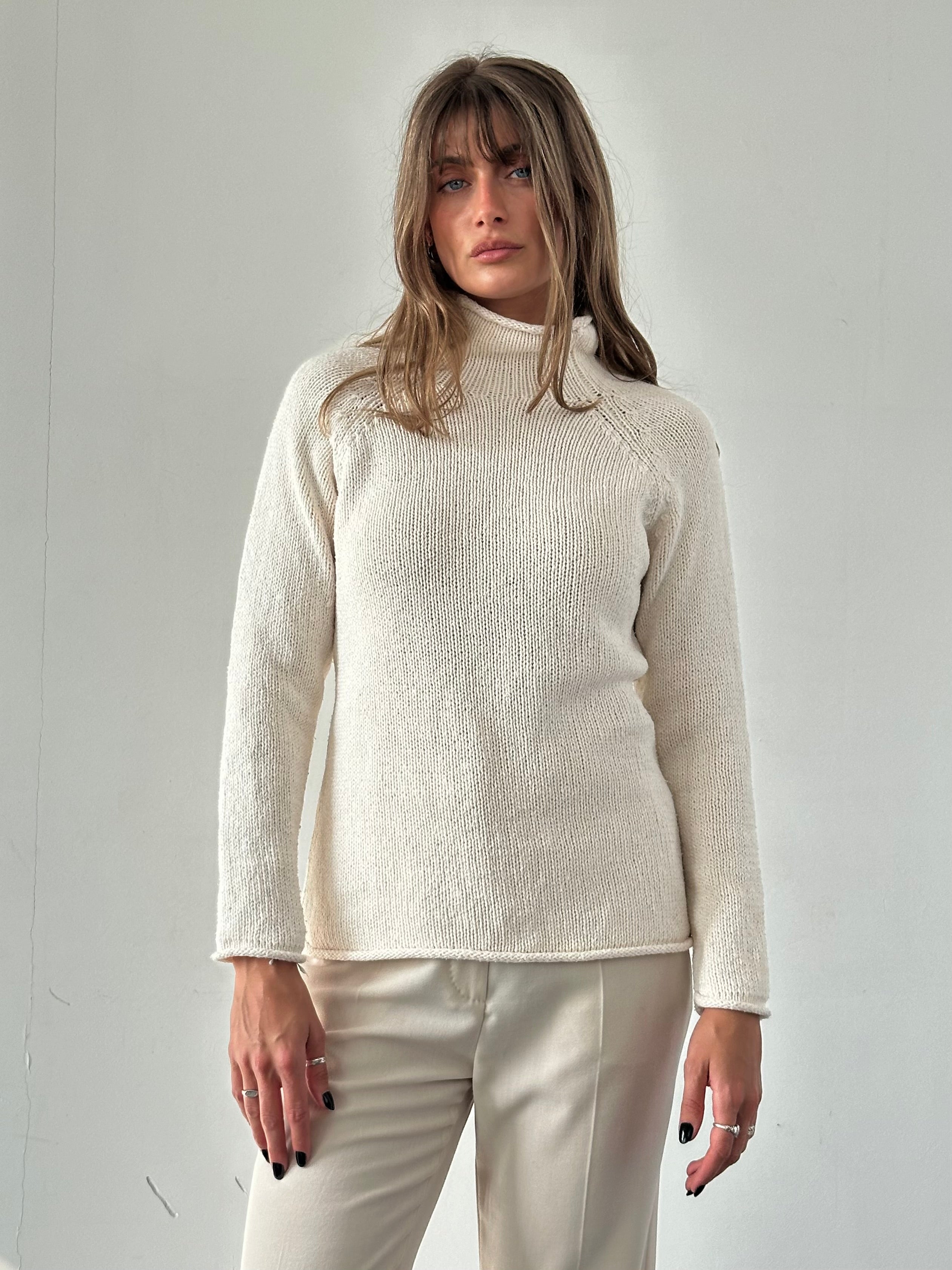 L.L.Bean pure cotton high neck jumper in size M, showcasing a navy blue, soft, knitted fabric with a high neckline and long sleeves.