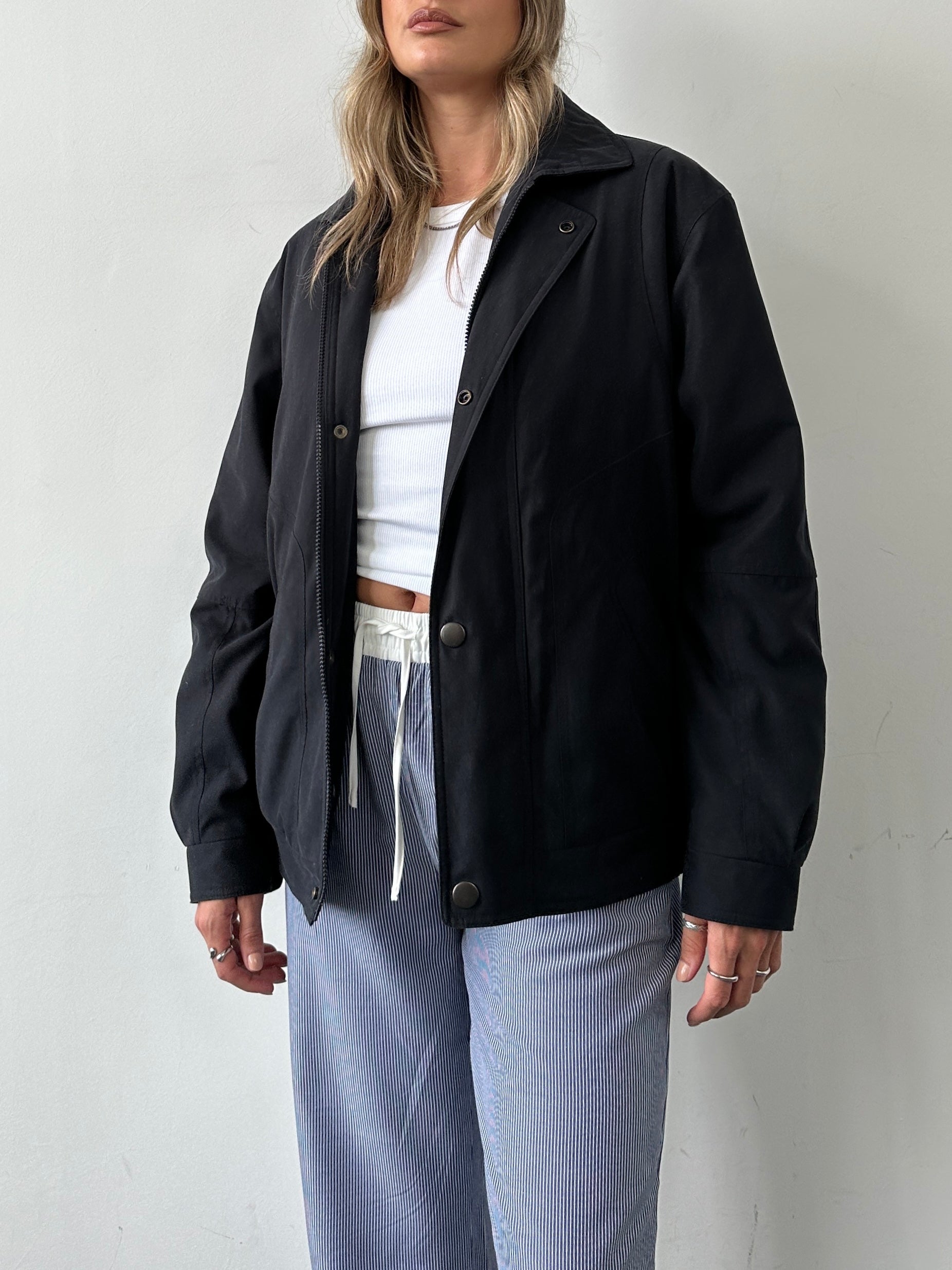 Vintage padded bomber jacket in size large, with a retro style, featuring quilted padding and a classic collar.