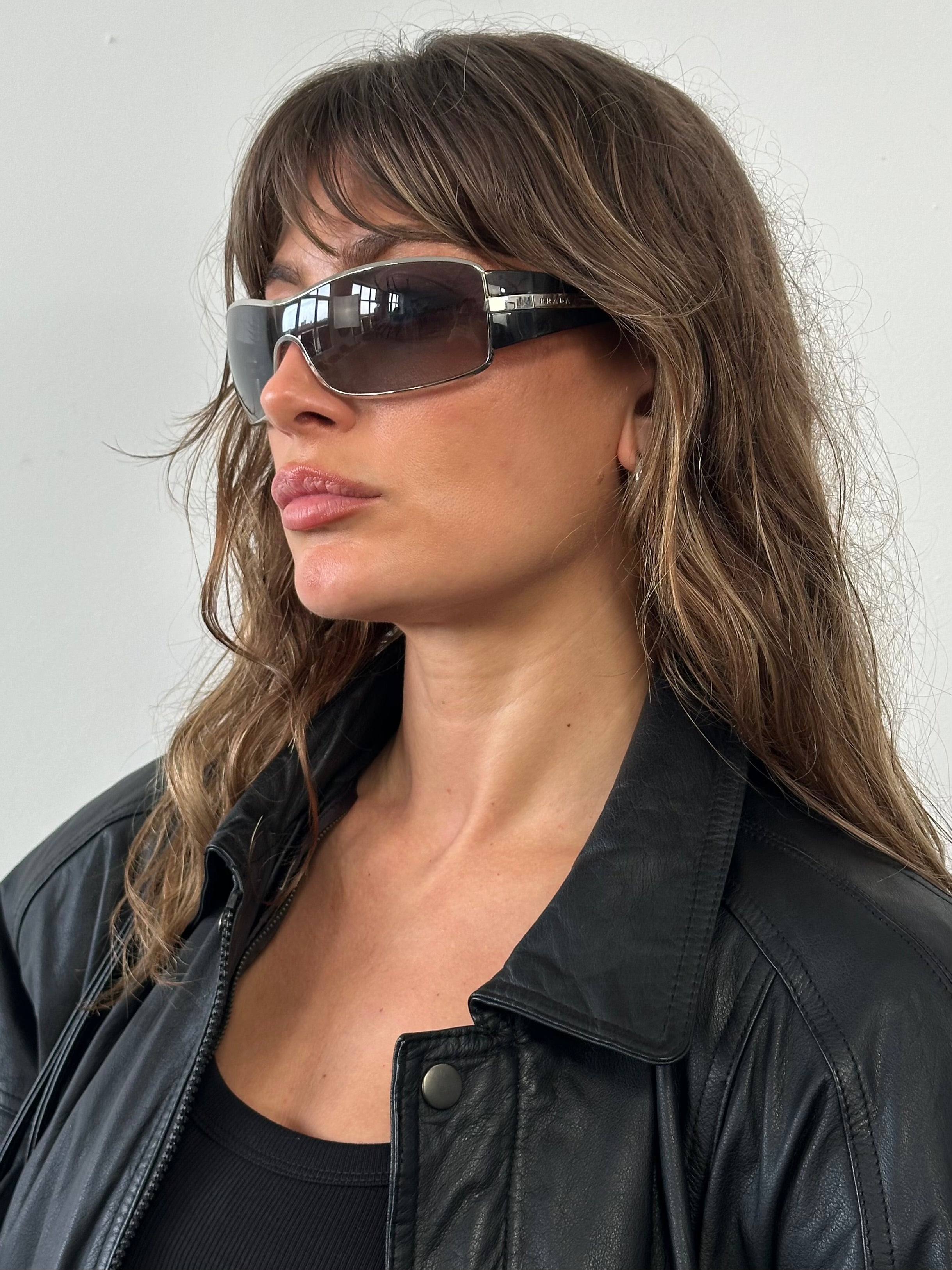 Prada 2000s aviator shield sunglasses with metal frame and dark lenses, stylish eyewear for sun protection.