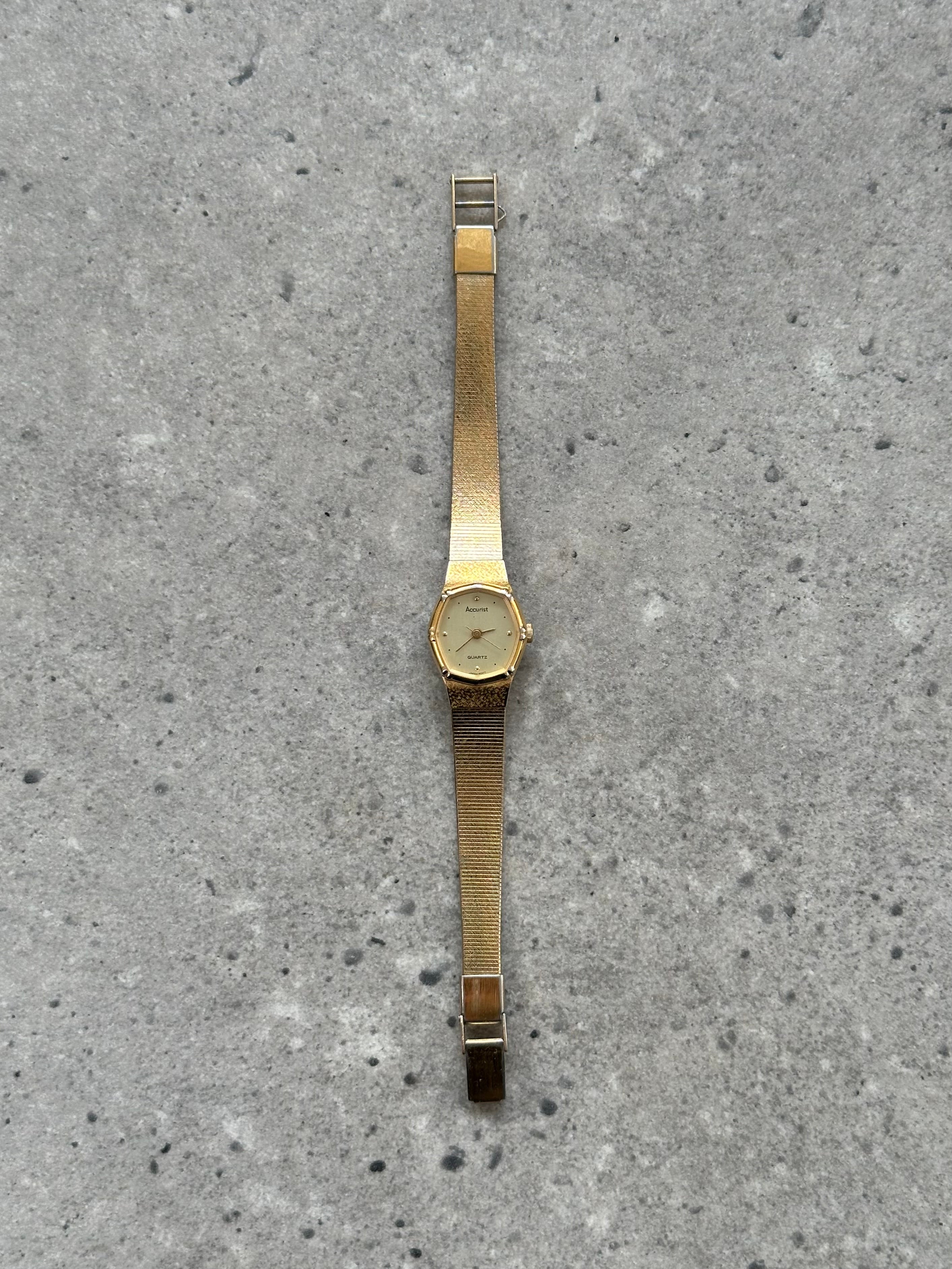 Accurist 1990s gold tone octagonal quartz watch showing the watch face with gold accents and octagonal case shape.