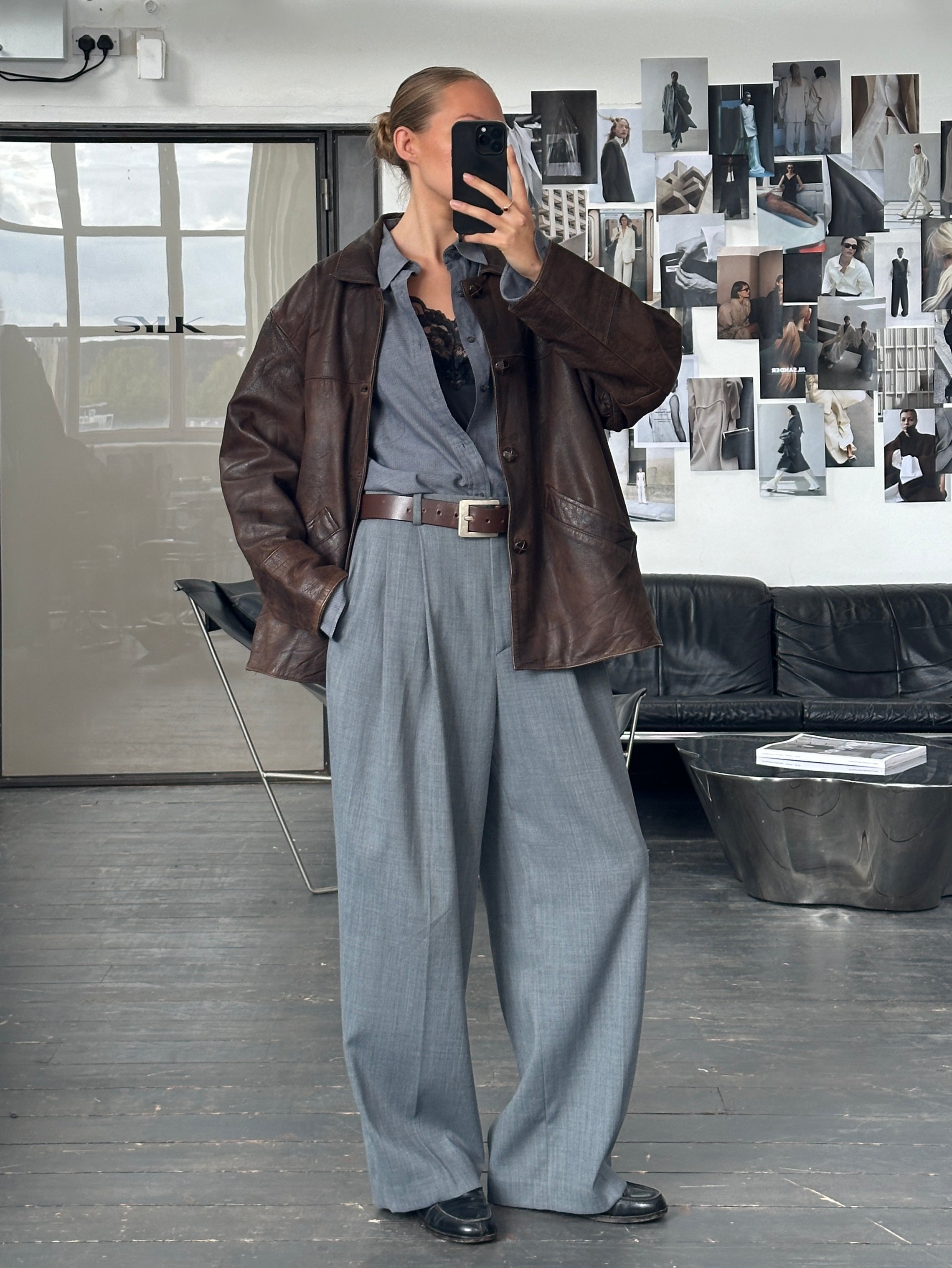 Vintage brand vintage 1980s aged boxy leather jacket in size XL, featuring distressed brown leather and classic design.