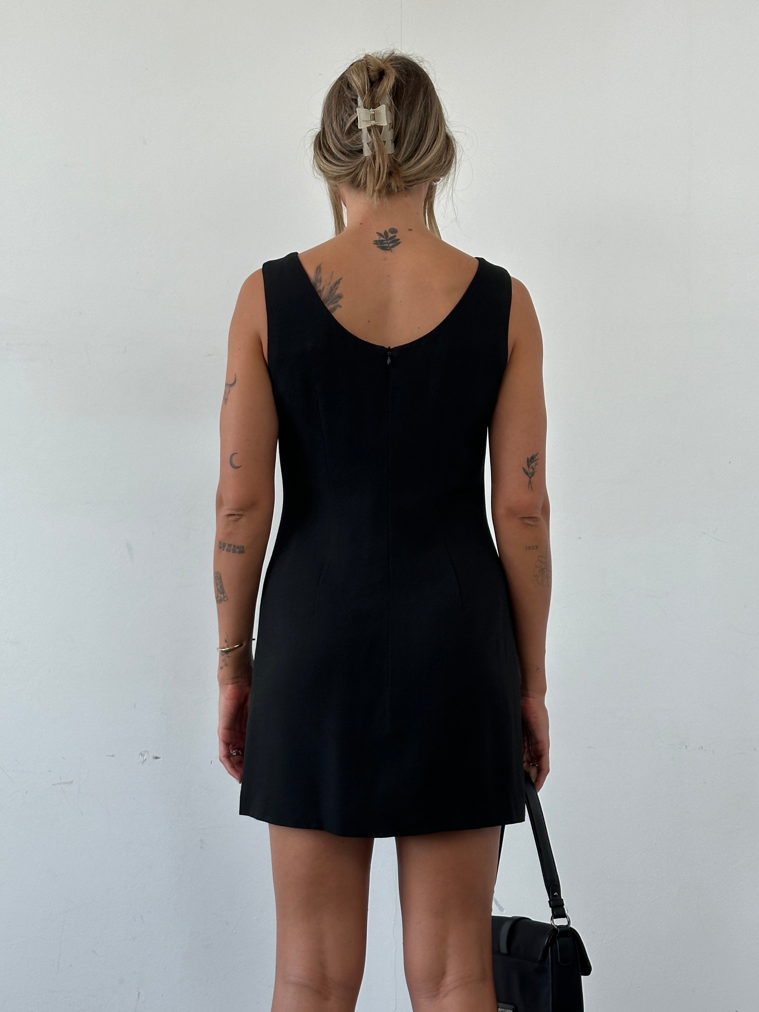 Dolce & Gabbana fitted mini dress in a sleek design, shown on a mannequin, with elegant details and a stylish silhouette.