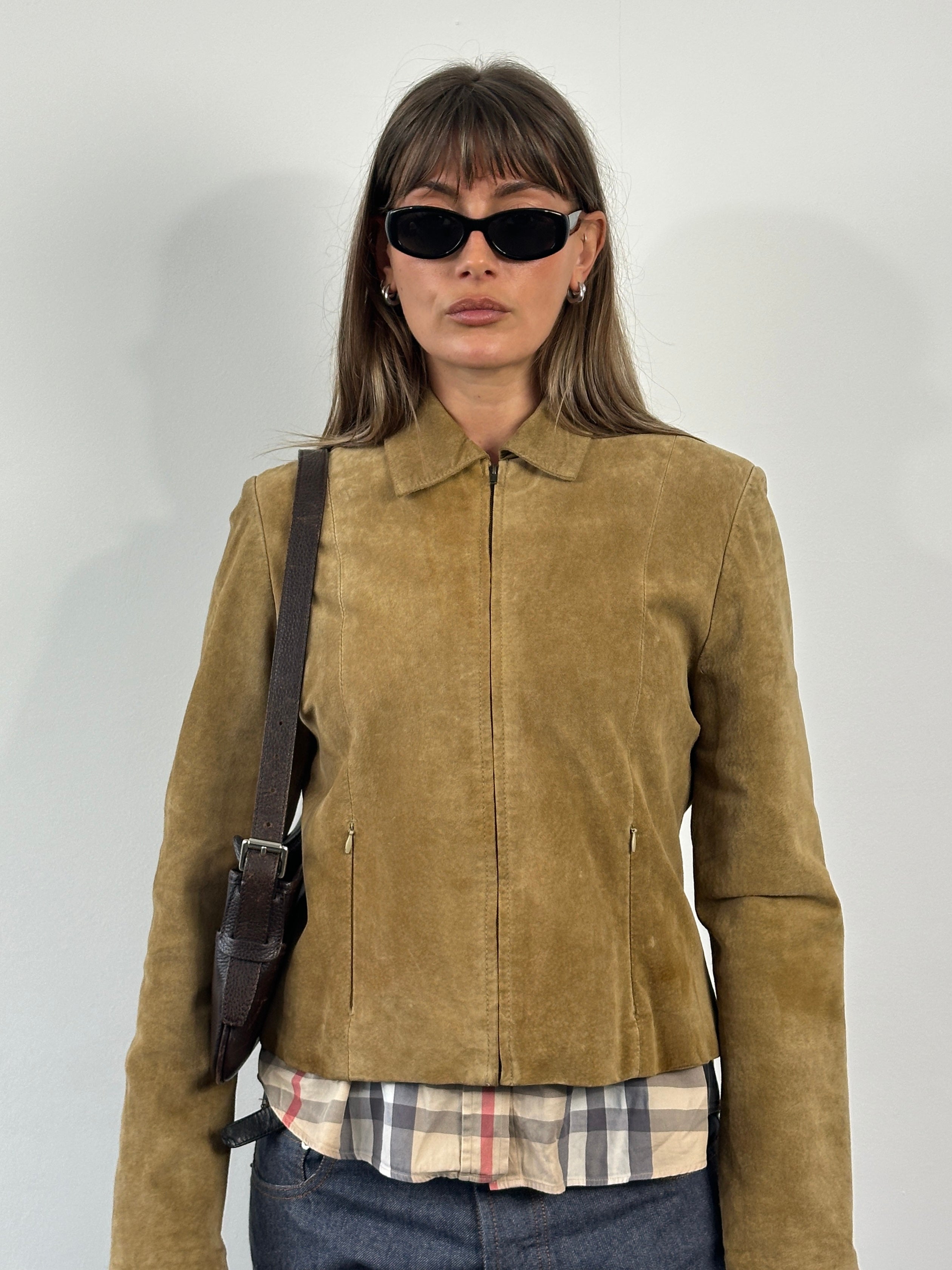 Vintage 1990s suede leather jacket in small size, featuring classic design and soft texture, displayed on a hanger.