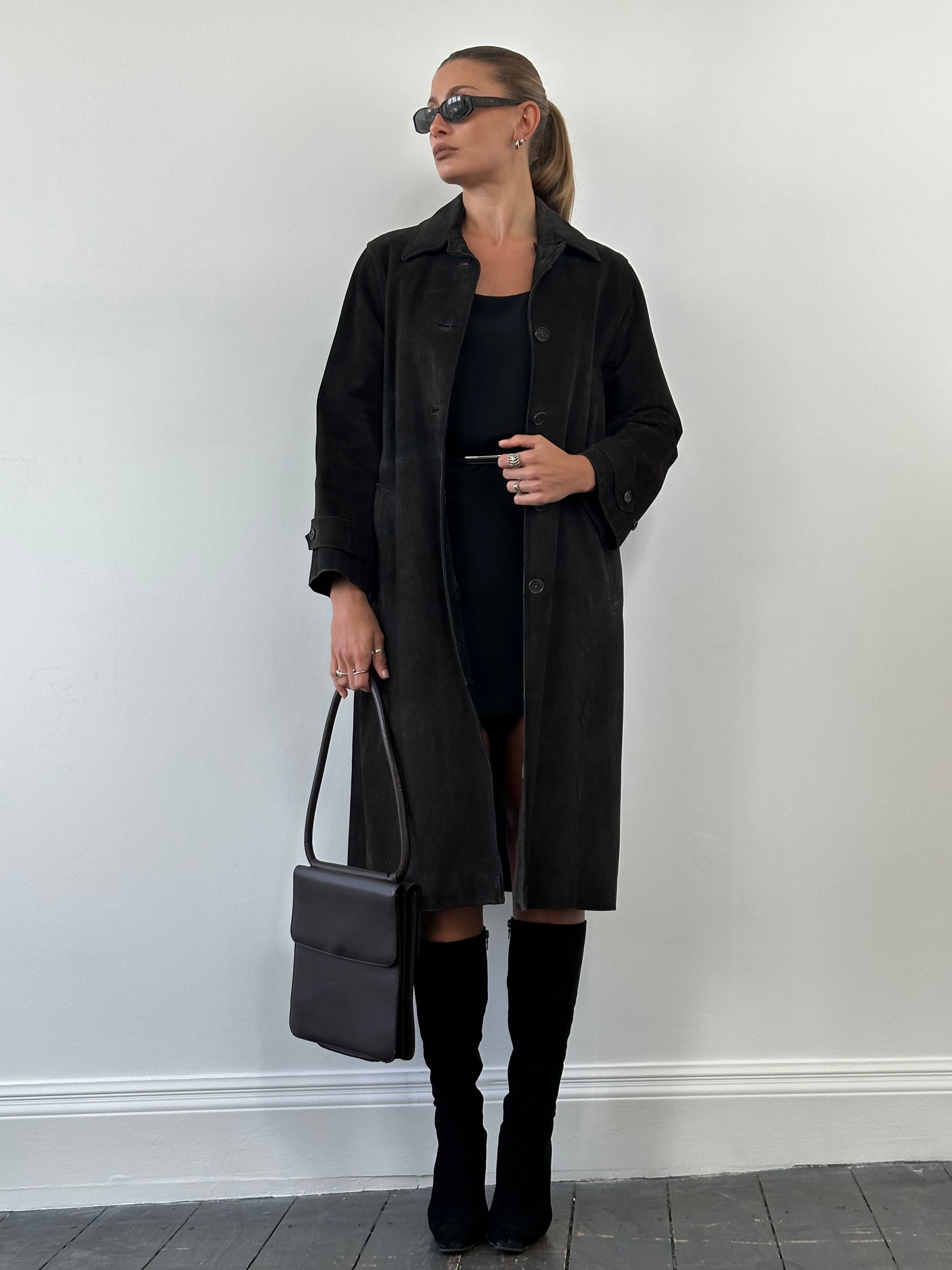 Vintage suede trench coat jacket in size M/L, featuring classic design and stylish details, displayed on a hanger.