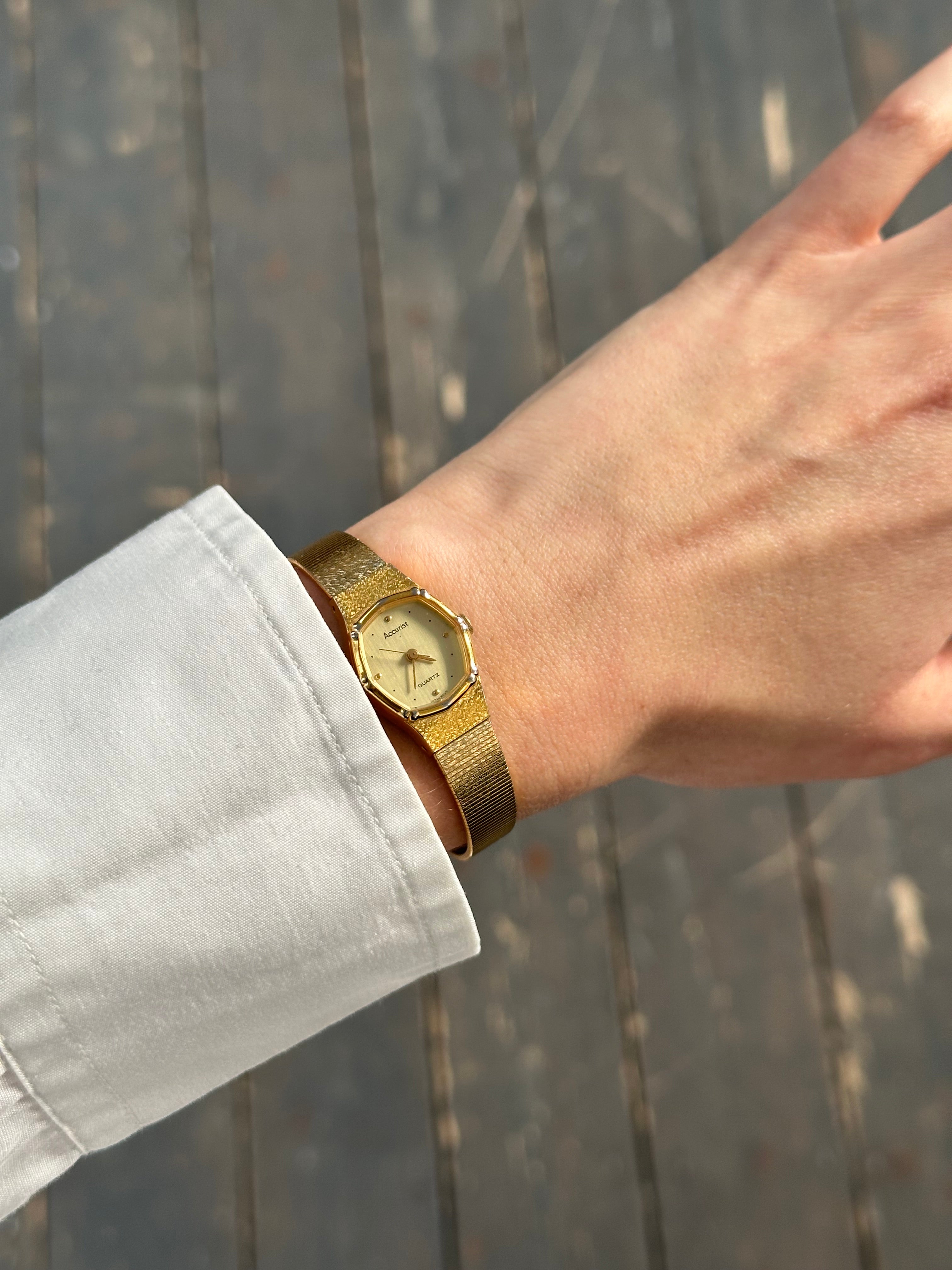 Accurist 1990s gold tone octagonal quartz watch with a stylish design and gold-colored dial and strap.