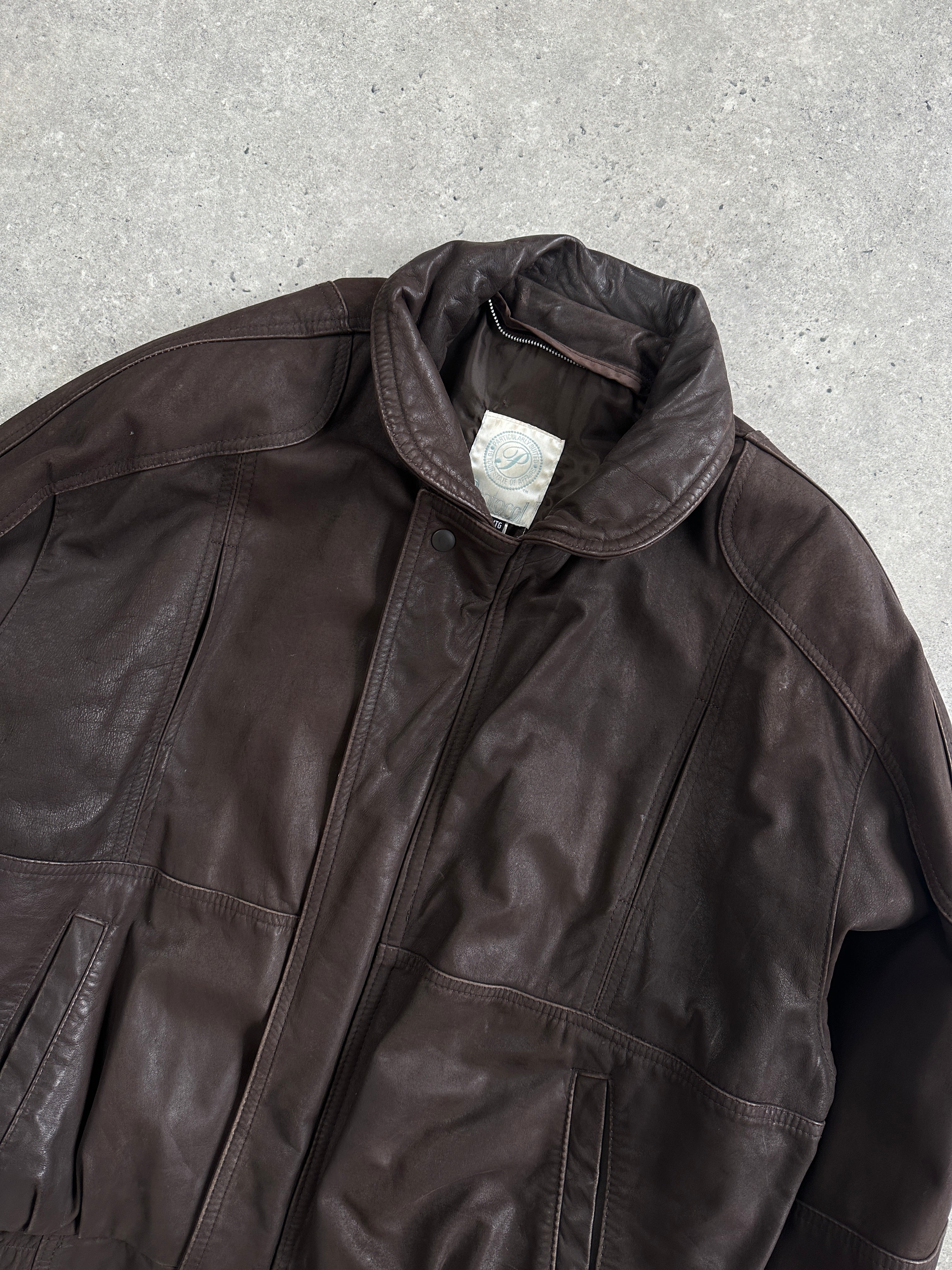 Vintage leather bomber jacket in XL size, featuring classic design with a rugged, aged leather appearance and metal zipper details.