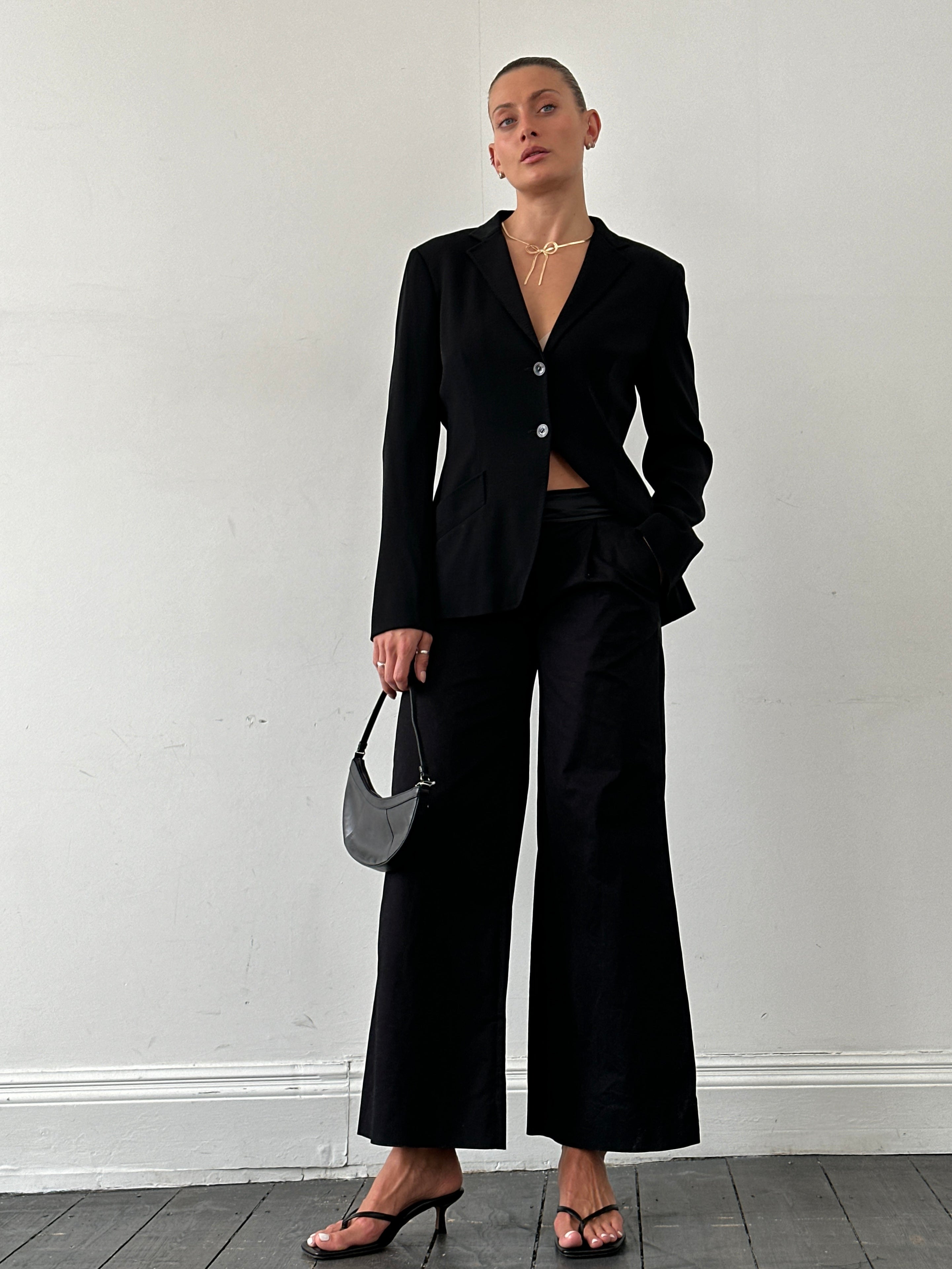Gianfranco Ferre wide leg low waist tuxedo trousers in black, shown flat with waistband and tailored fit.