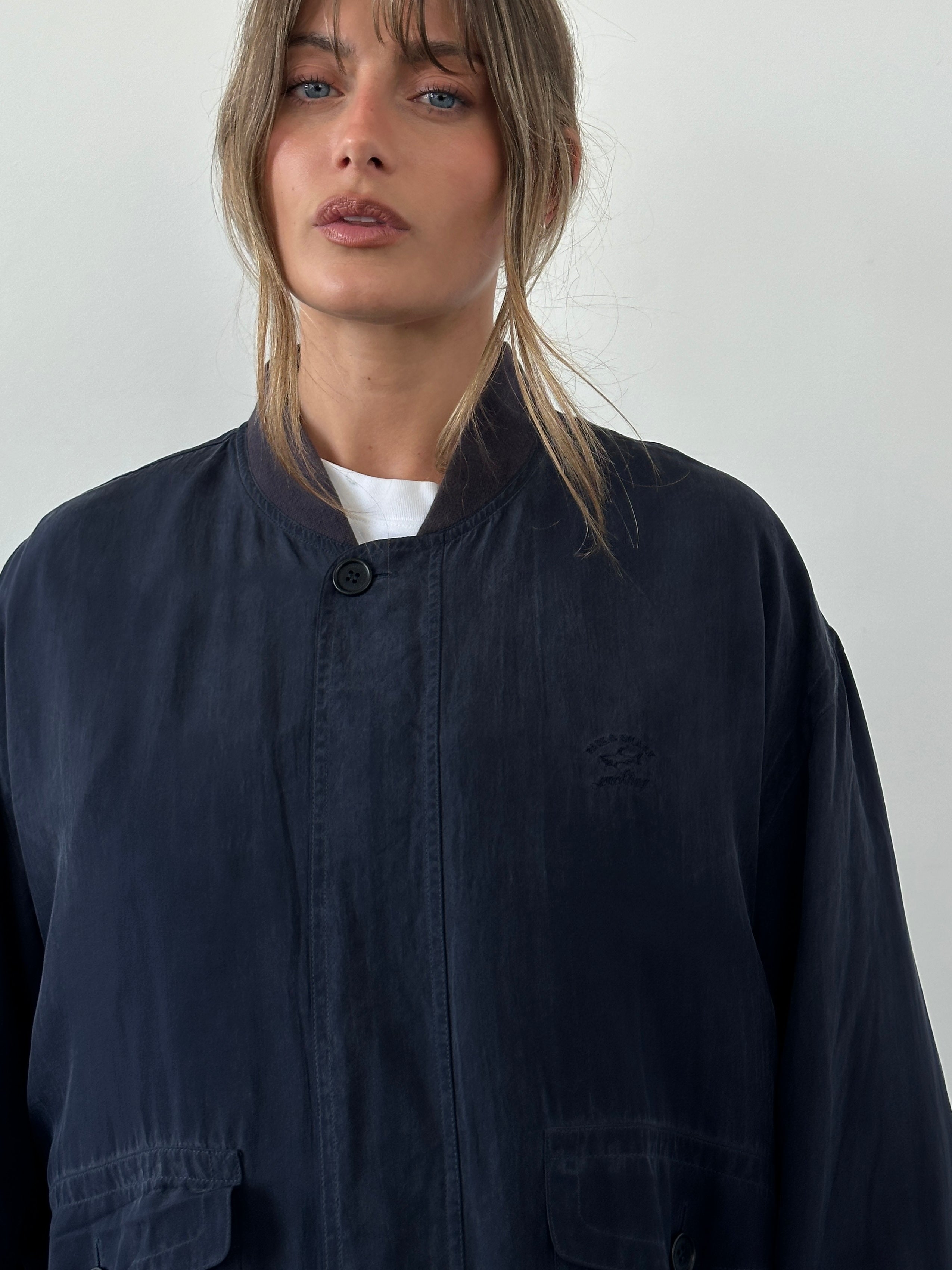 Paul & Shark pure silk bomber jacket in XXL displayed on a hanger, showcasing its sleek design and smooth silk fabric.