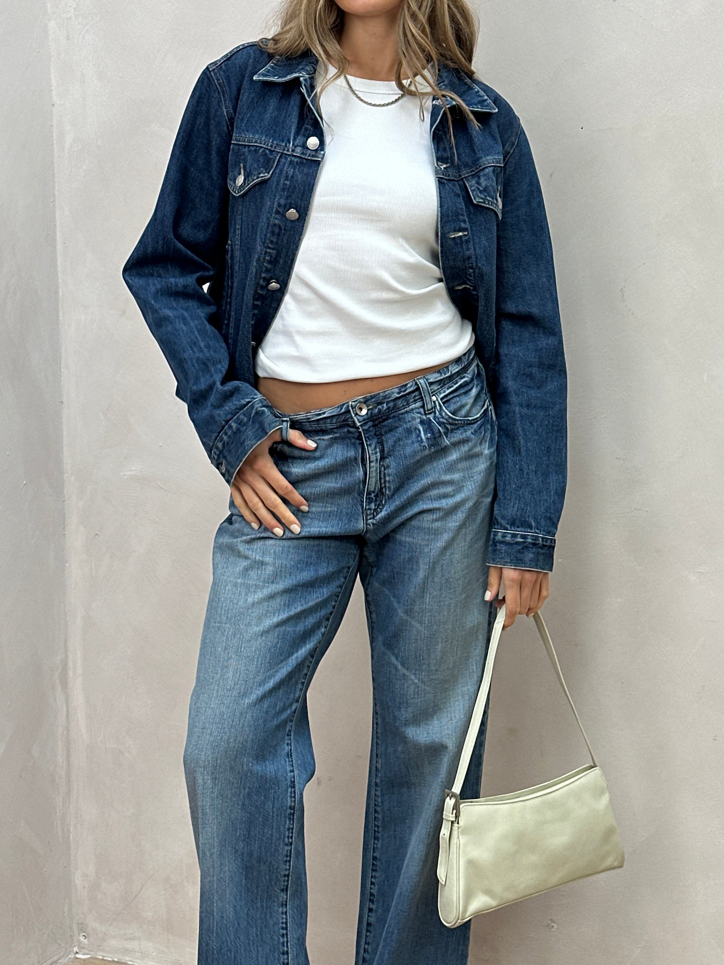 Armani Jeans mid wash denim jacket in size S/M with classic design and button closure, displayed on a plain background.