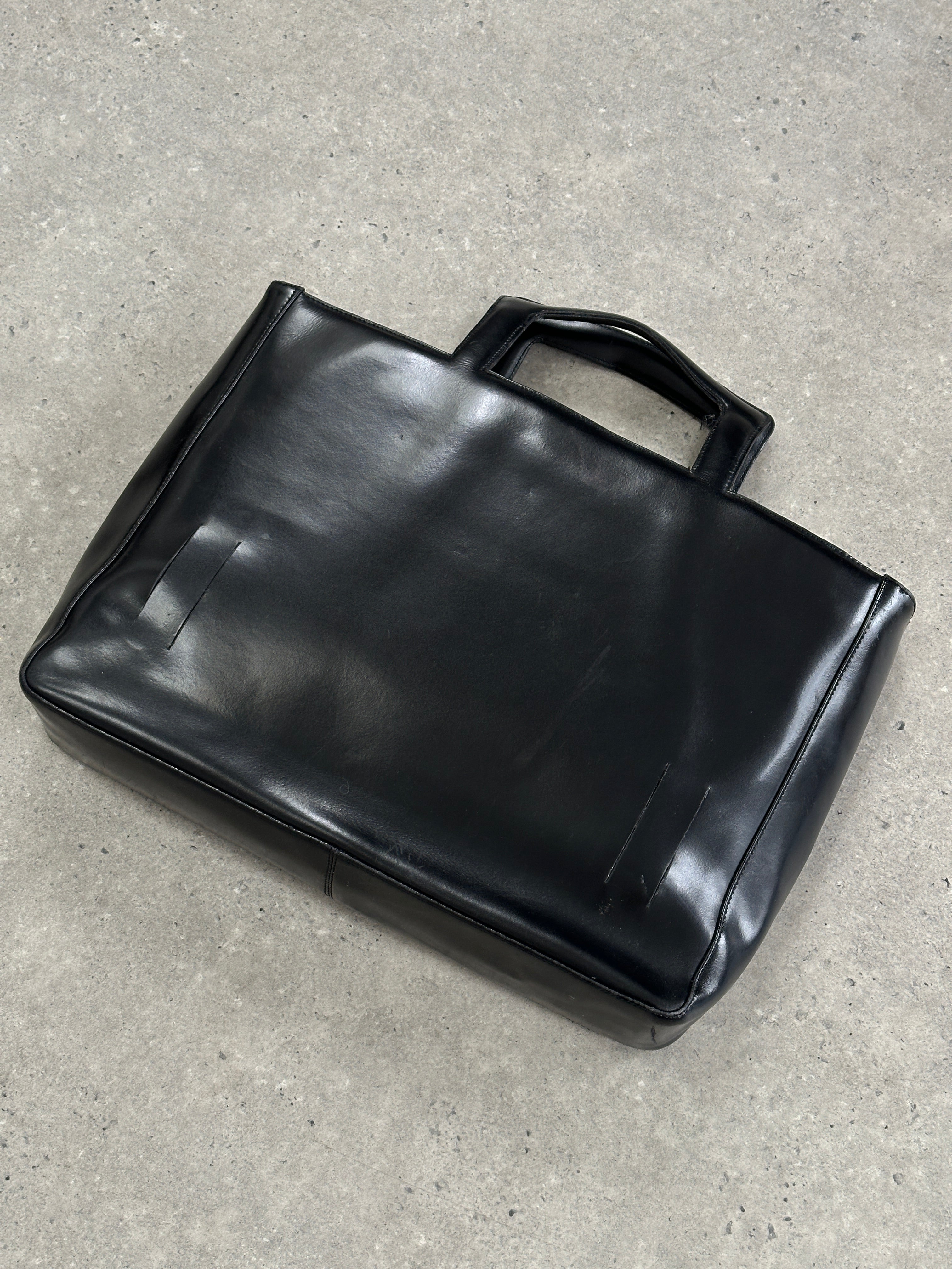Vintage Italian leather briefcase bag with classic design, featuring sturdy handles and a polished finish.