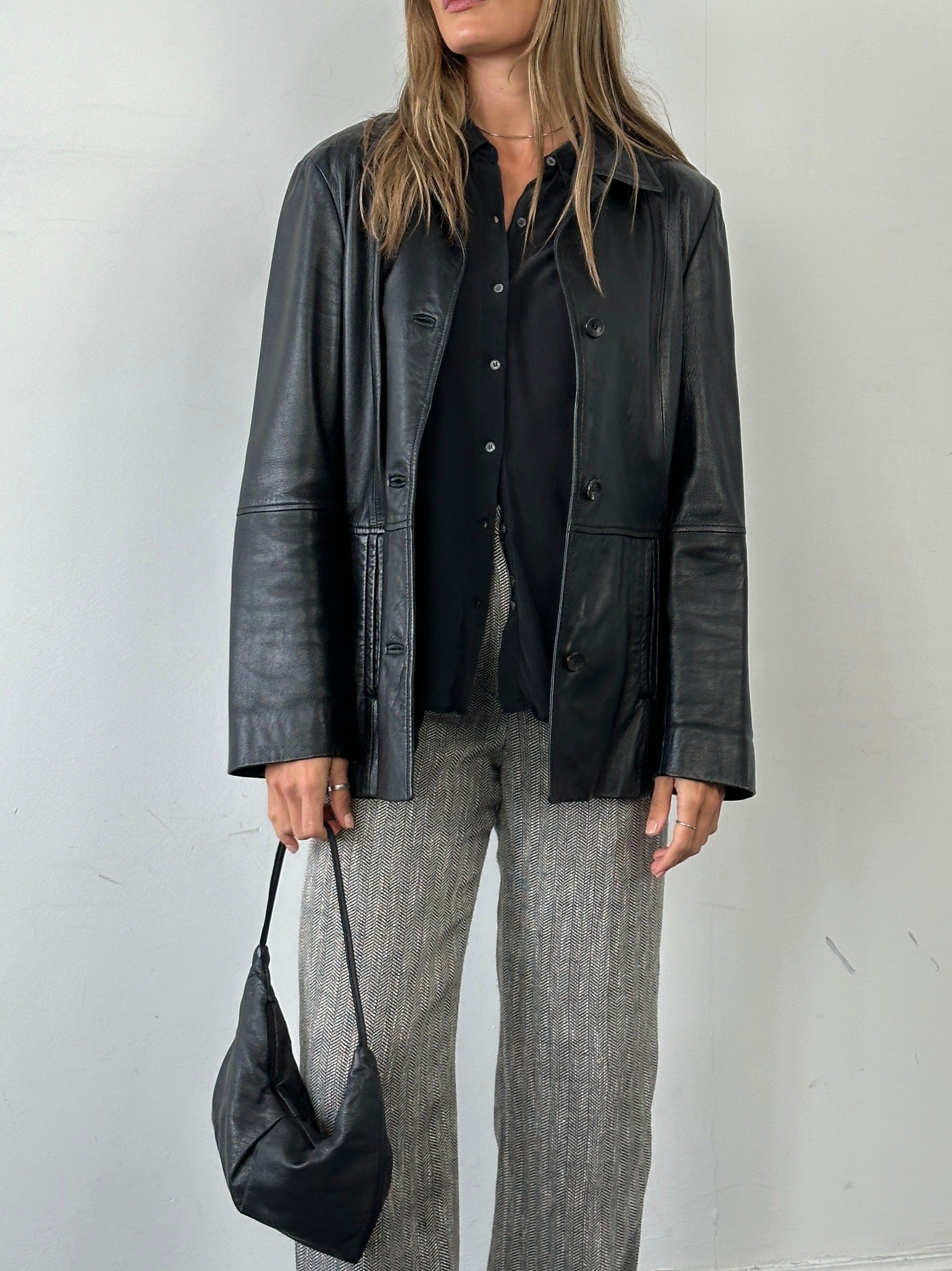 Marella smooth leather jacket in size M, black, with a sleek design and classic collar, displayed on a hanger.