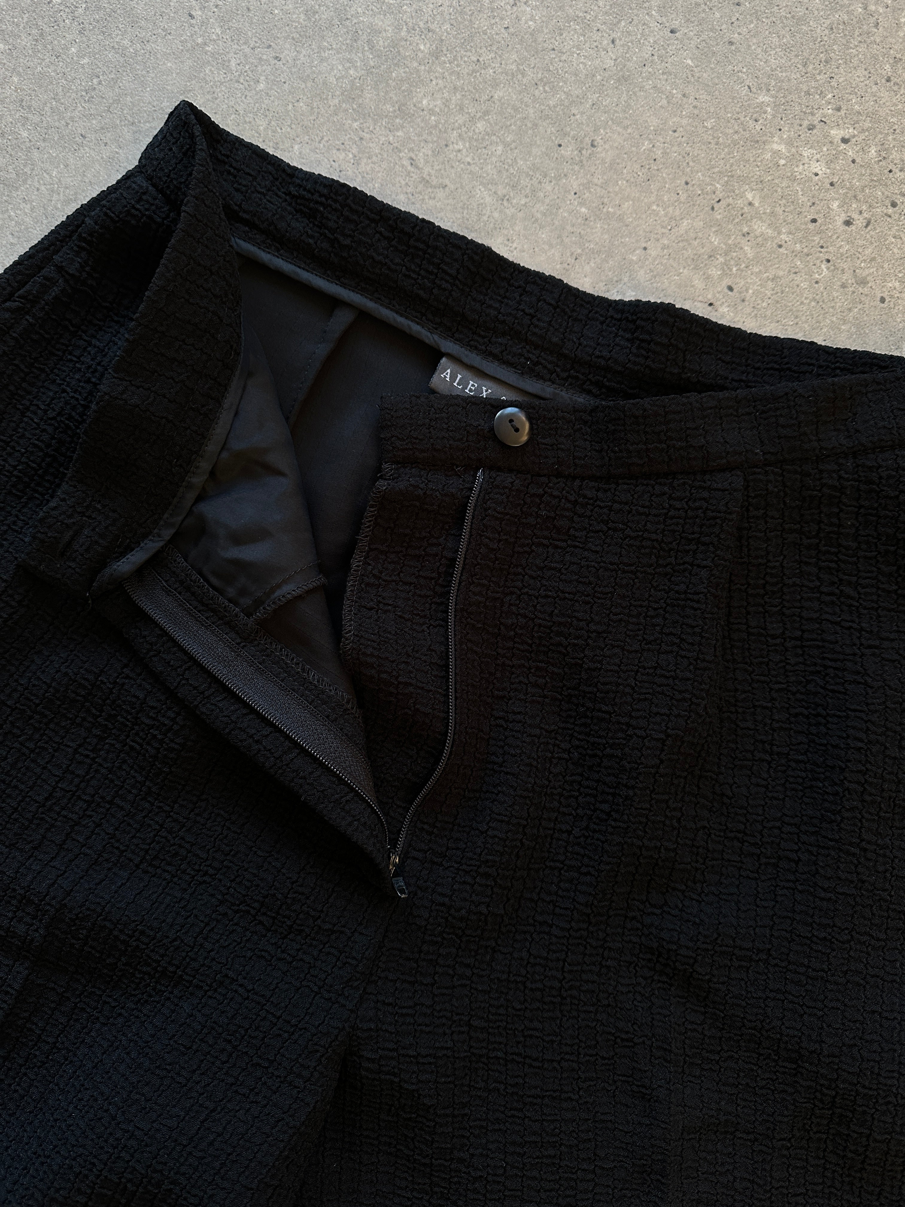 Vintage high waisted textured trousers in size W26, featuring a classic fit and detailed fabric pattern.