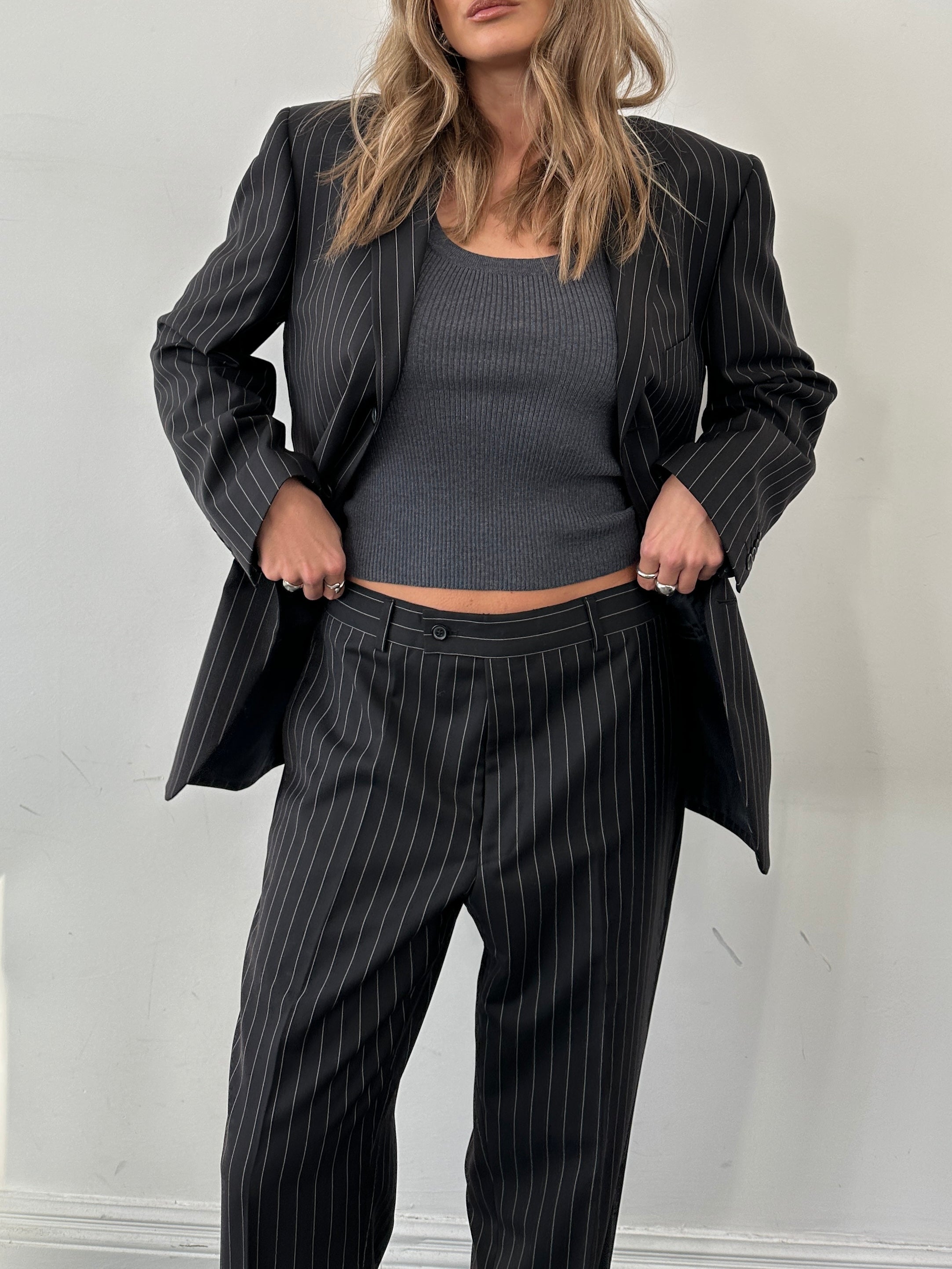 Yves Saint Laurent pinstripe wool jumpsuit in size 40S/W34, tailored with a sleek, professional fit and classic pinstripe pattern.