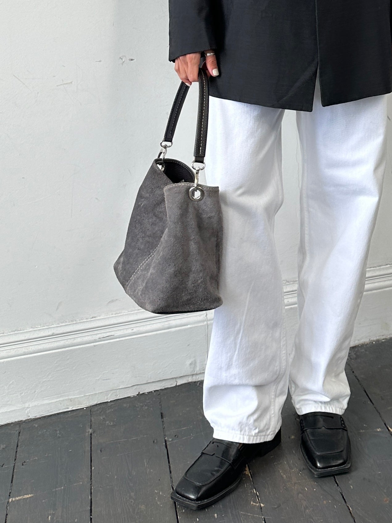 Vintage suede leather shoulder bag with adjustable strap, showcasing a classic design and rich texture.