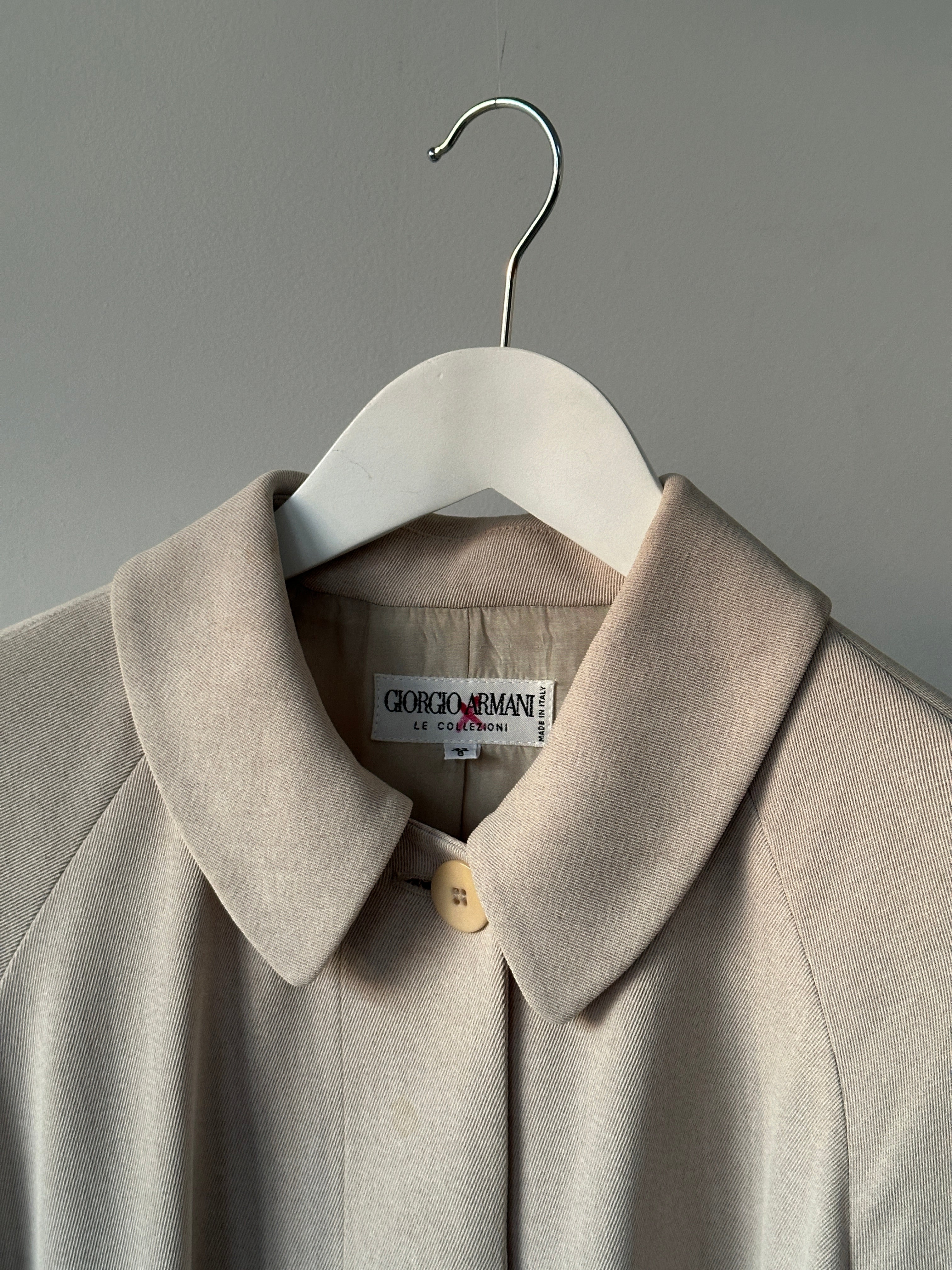 Giorgio Armani Le Collezioni wool floor-length belted coat in beige with wide lapels and long sleeves.