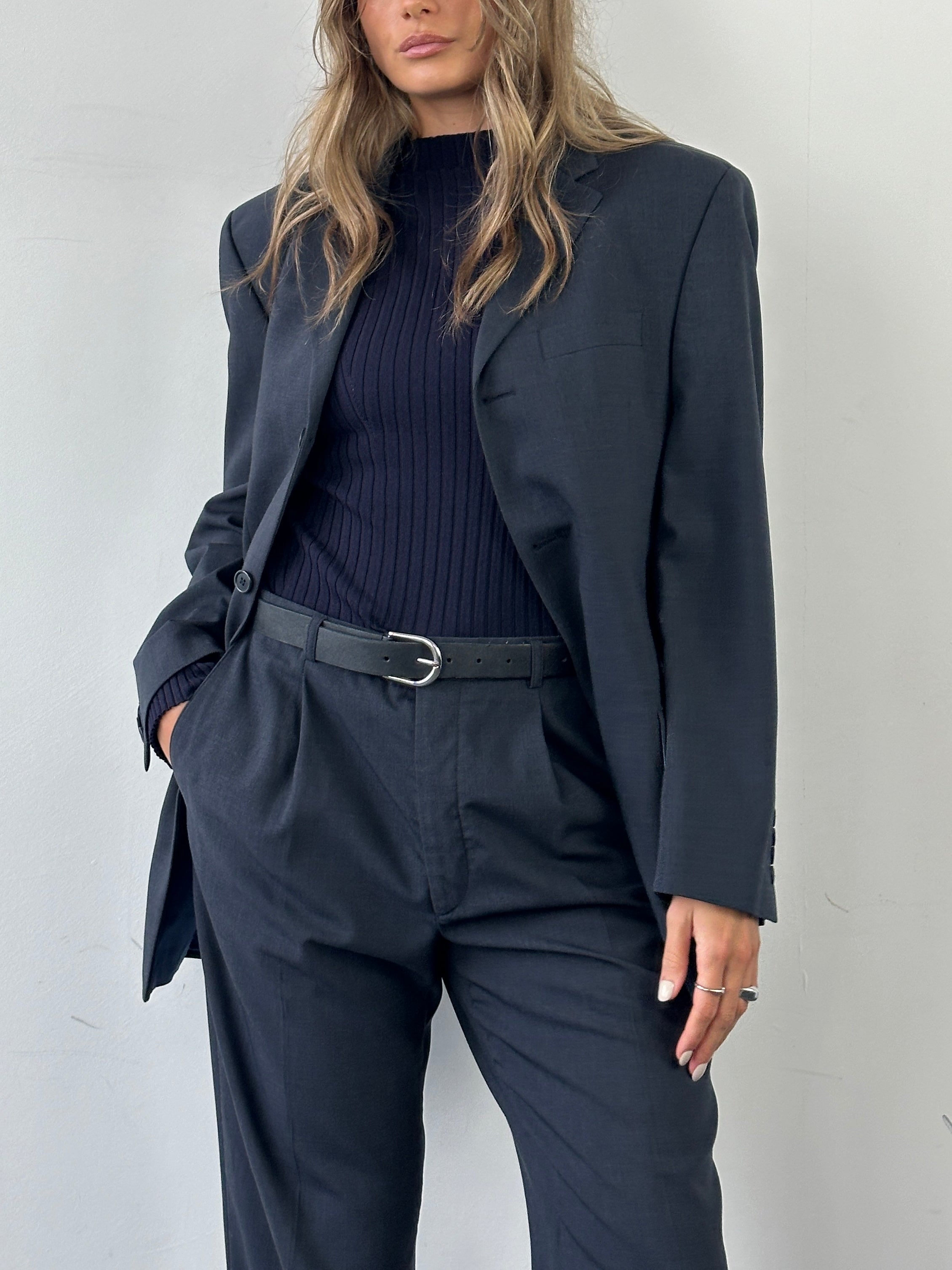 Vintage wool single-breasted jumpsuit in size 38R/W30, featuring tailored fit and classic design, displayed on a hanger.