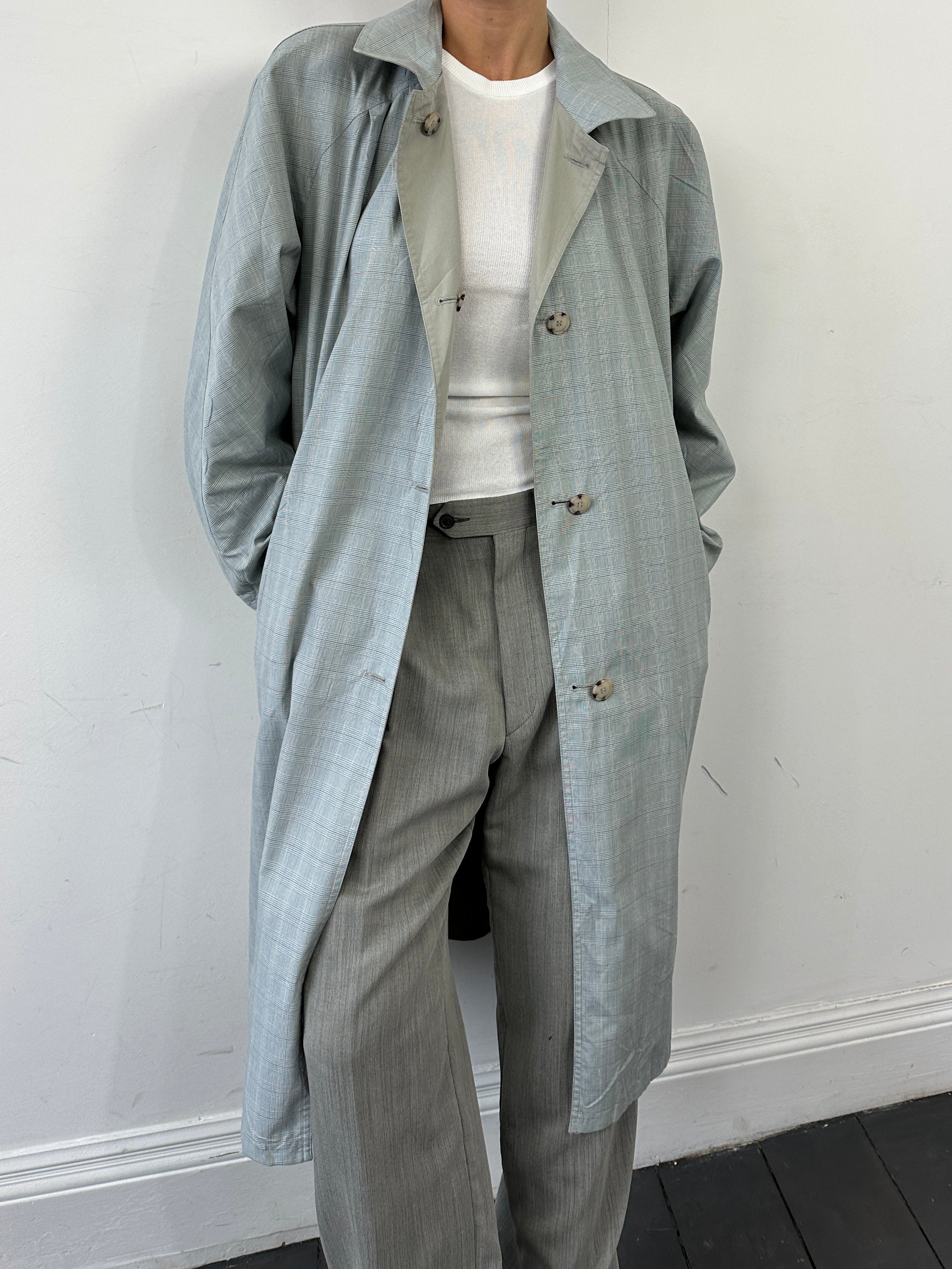 Vintage reversible showerproof check trench coat with belted waist in size large, stylish and functional outerwear.