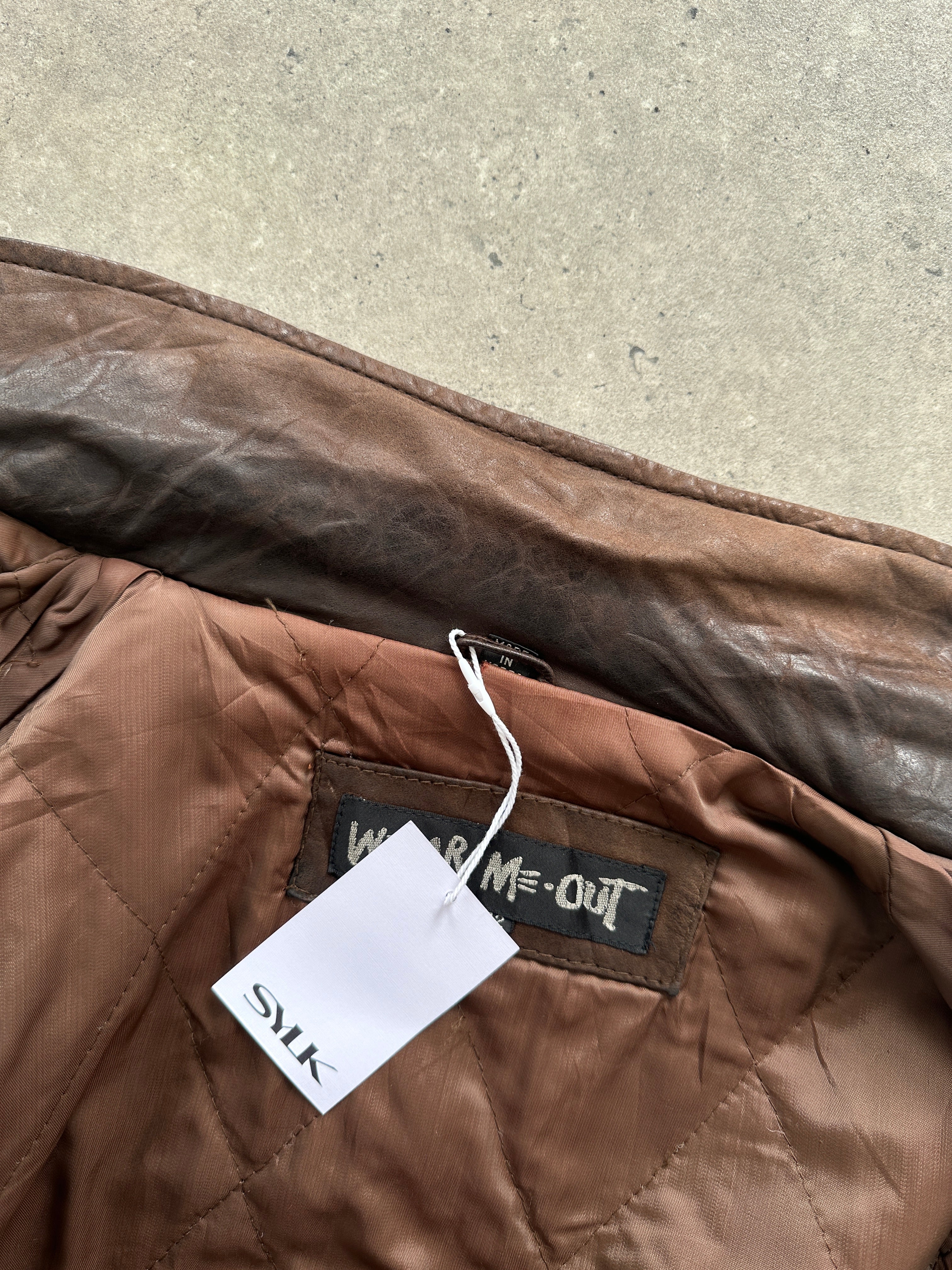 Vintage distressed leather bomber jacket in size L, featuring rugged design and classic style.