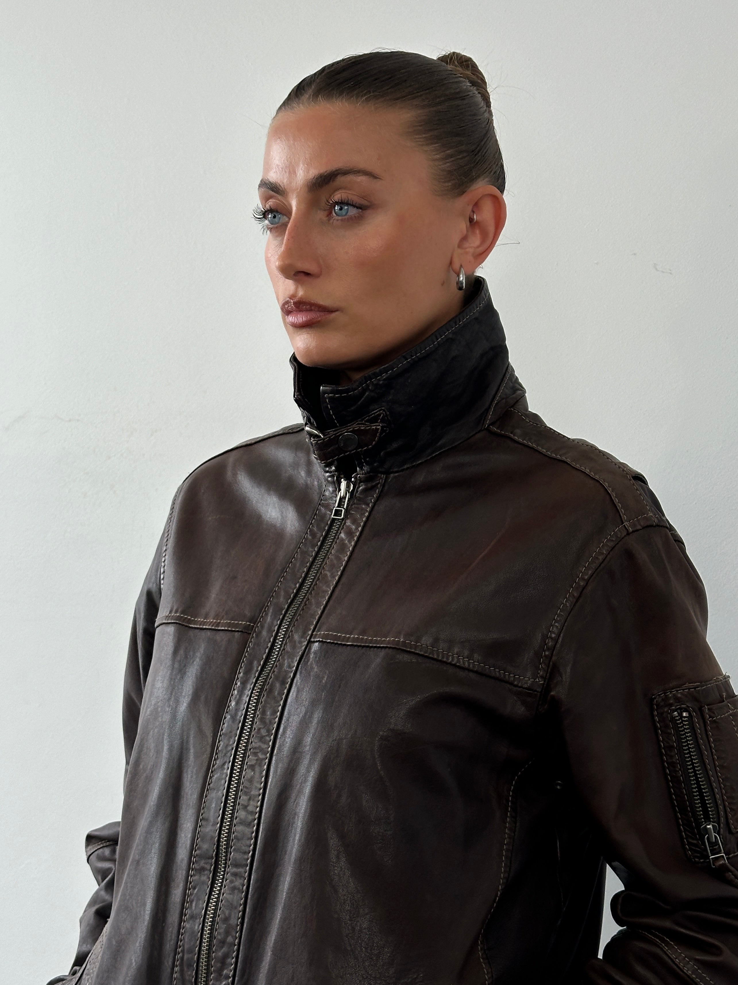 Vintage Moto aged leather jacket in size L, featuring a classic design with distressed brown leather and metal zipper details.