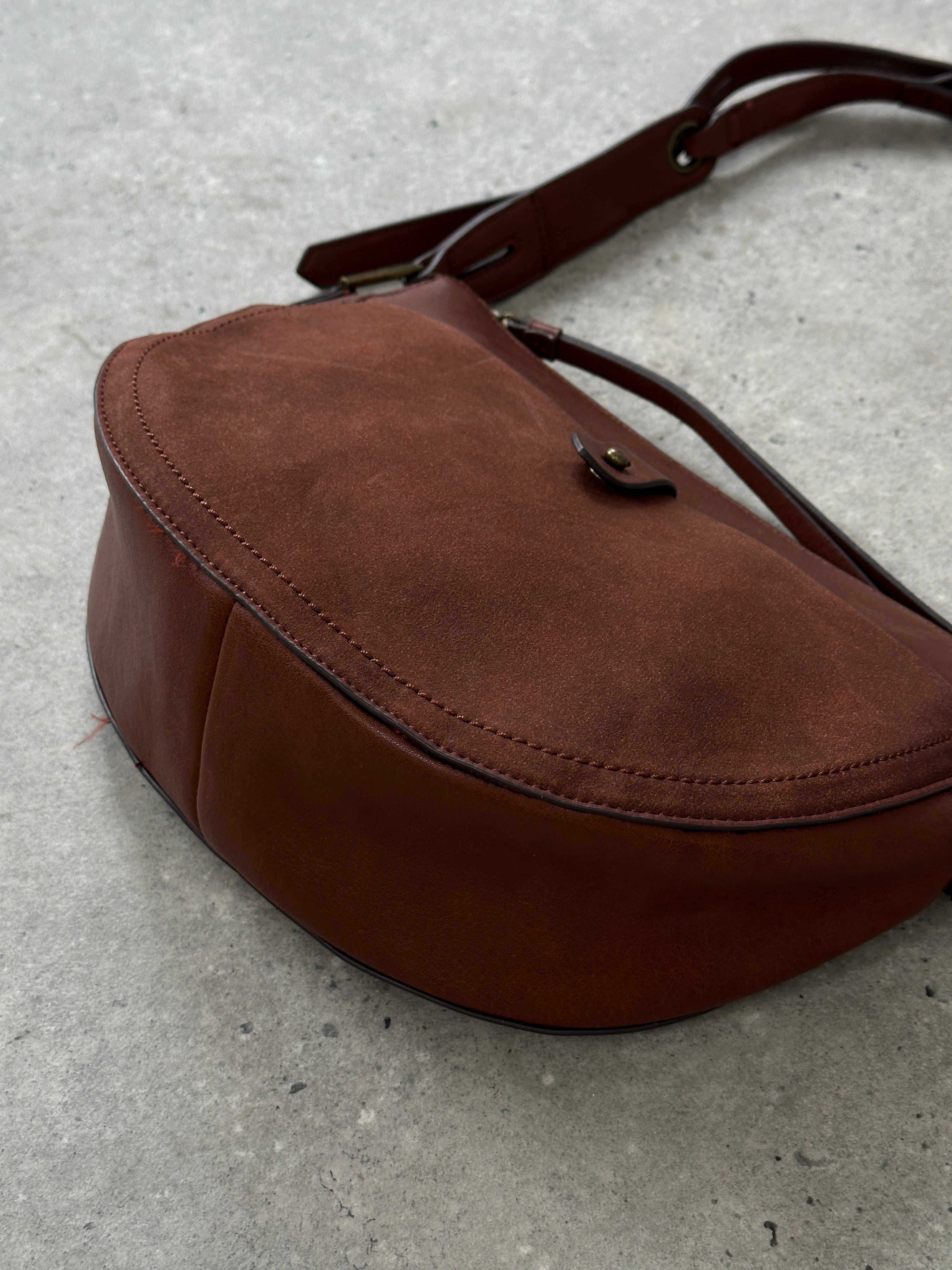 Vintage faux leather crescent crossbody bag with adjustable strap and minimalist design, perfect for casual or chic outfits.