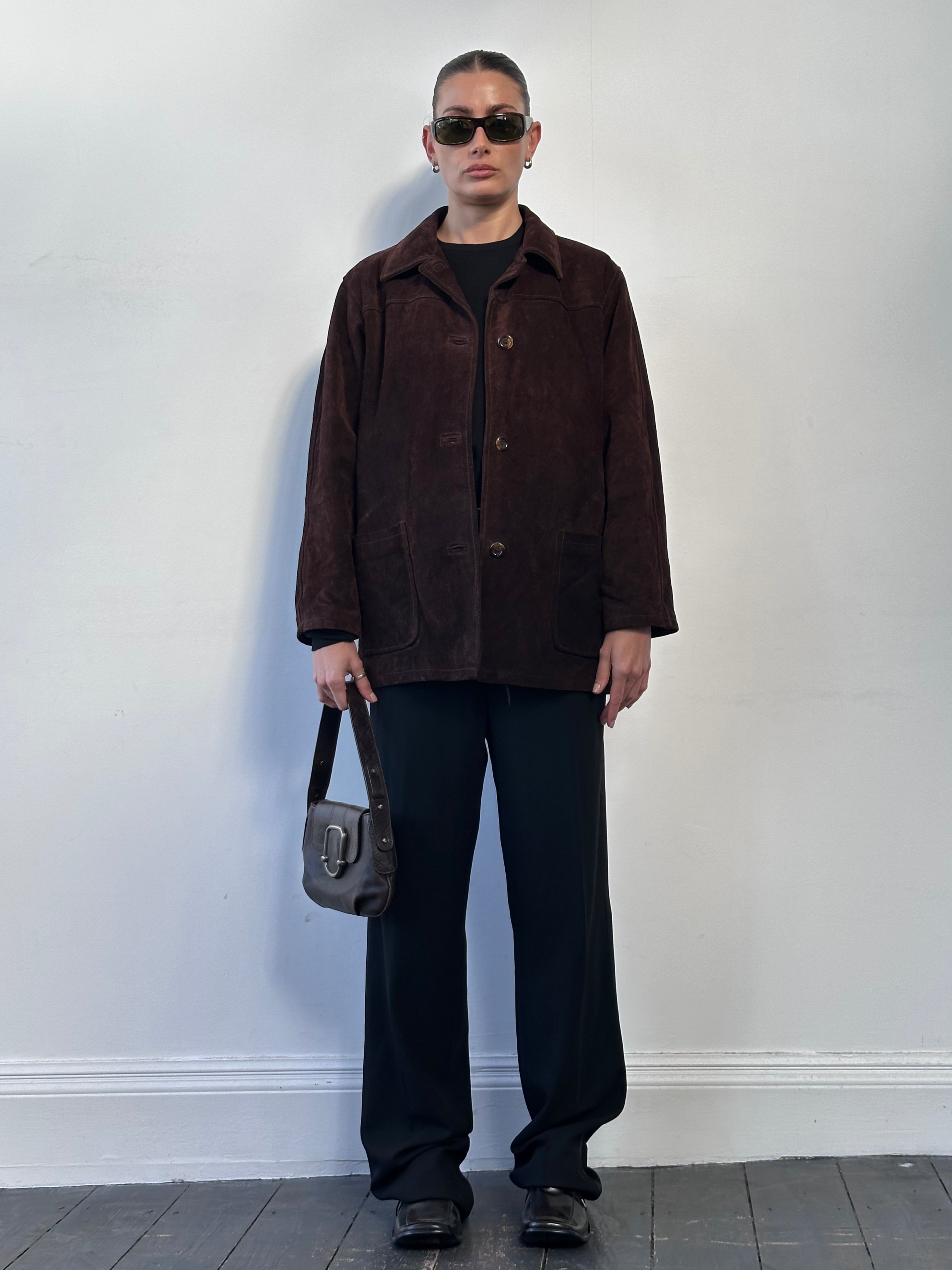 Vintage brand vintage suede leather jacket in size M/L with classic design and textured suede material.
