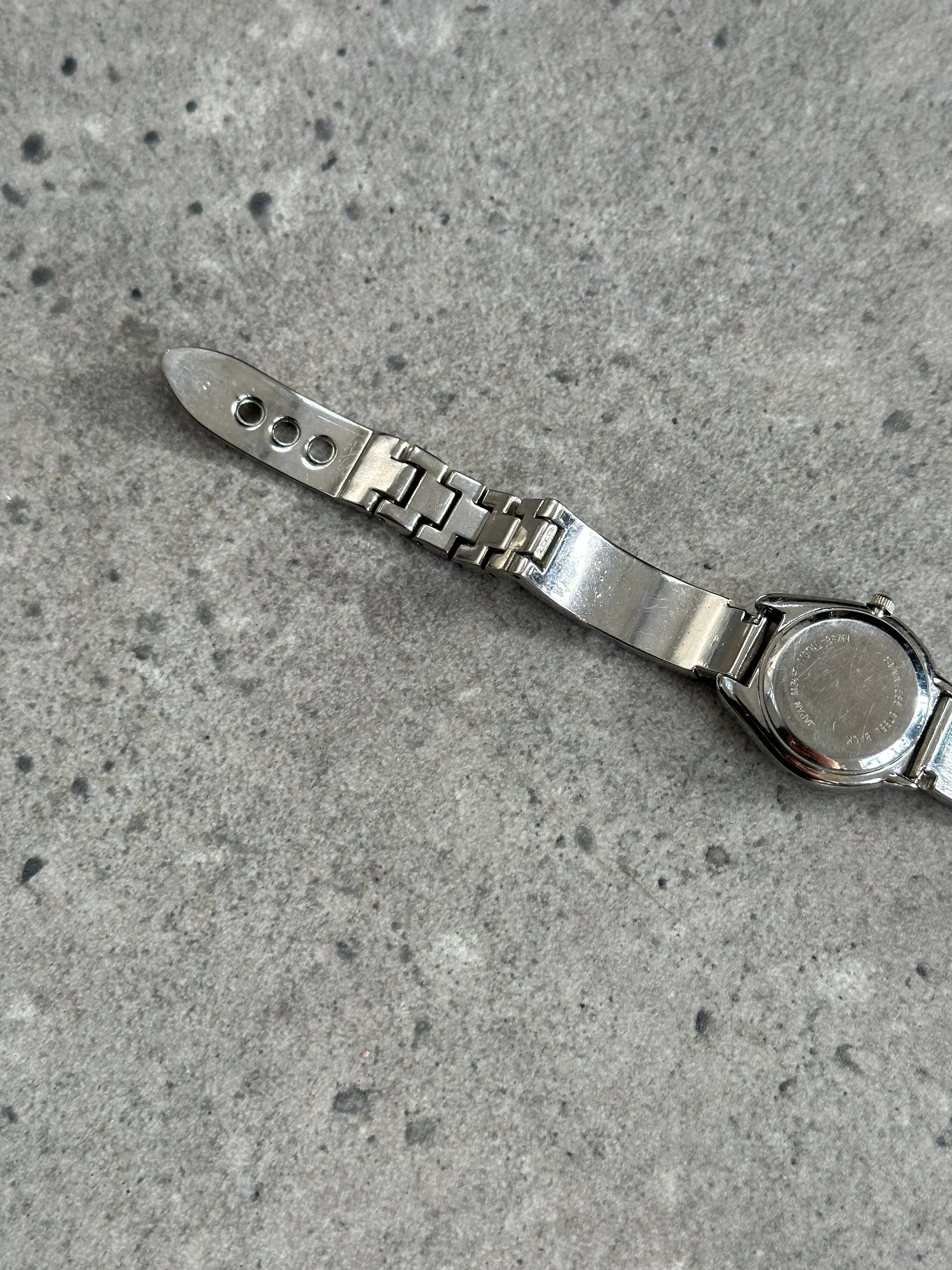 Gucci 1990s stainless steel quartz watch with sleek design and round dial, showcasing luxury and vintage style.