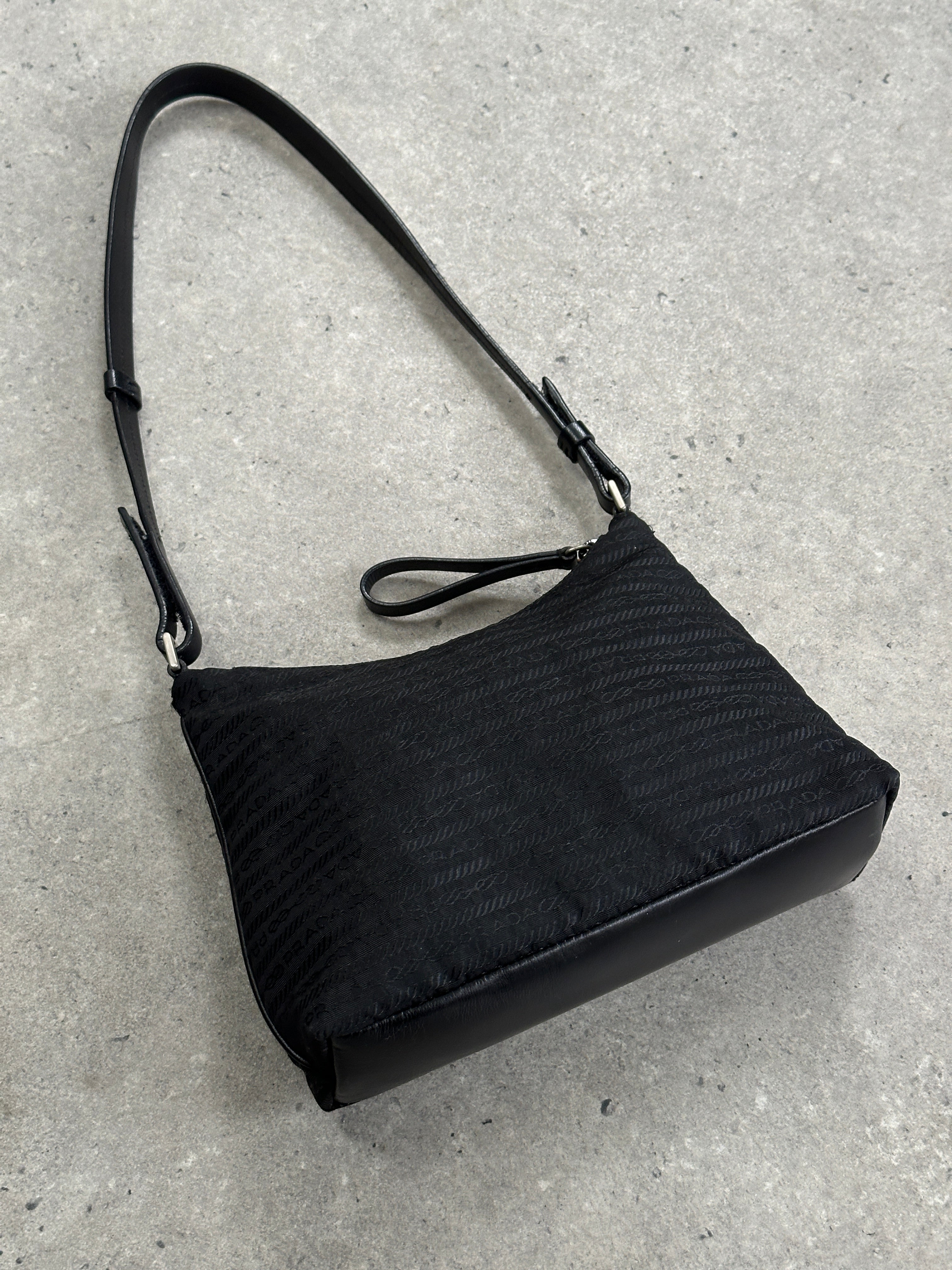 Prada Nylon Tessuto Monogram crossbody bag with adjustable strap and Prada logo, featuring a sleek nylon design and monogram pattern.