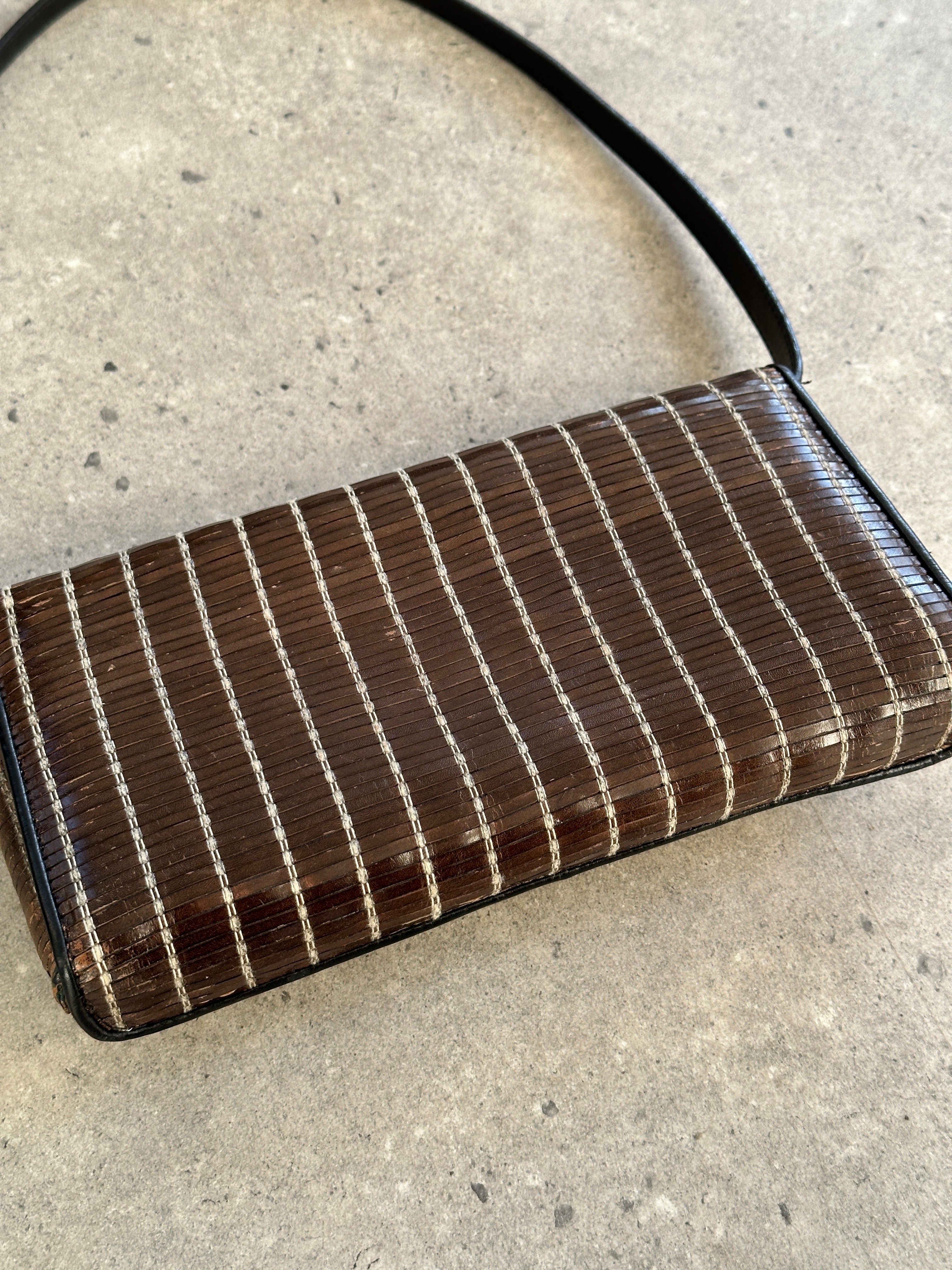 Giorgio Armani leather handbag with sleek design, top handle, and subtle branding, perfect for elegant everyday use.