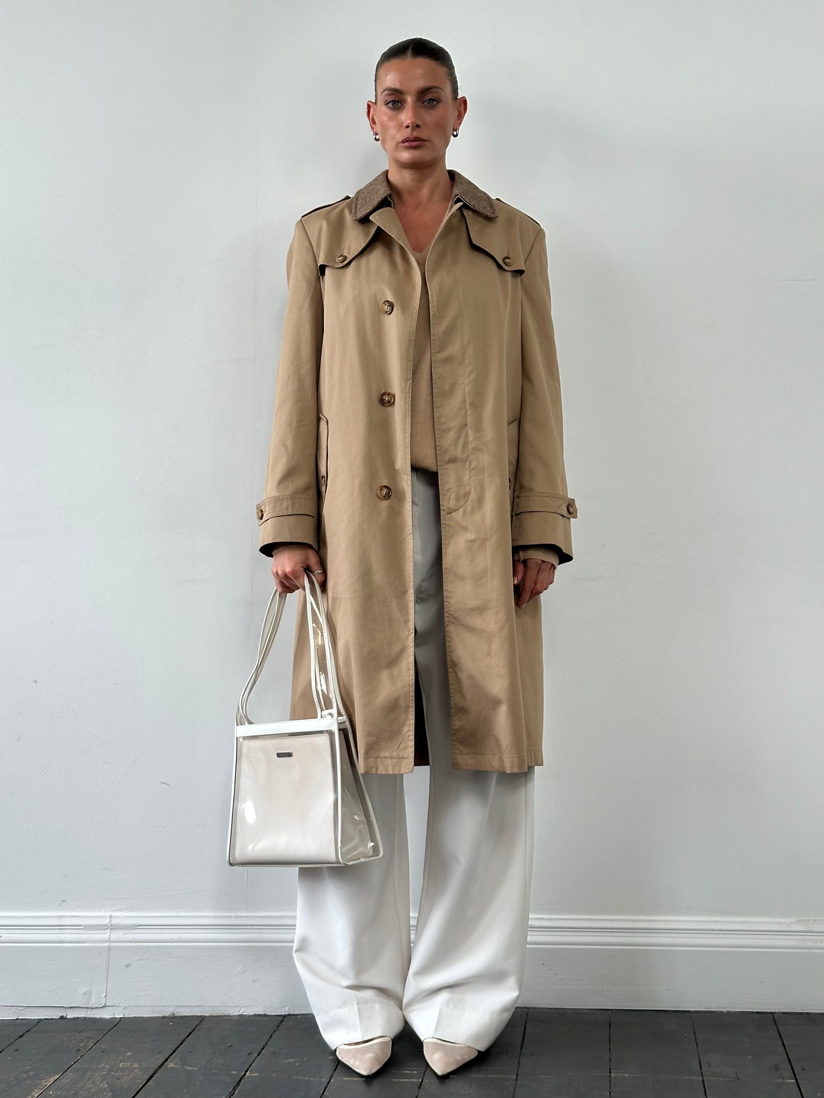 Christian Dior Monsieur cotton trench coat with belted waist, single-breasted design, in classic neutral color, displayed on a hanger.
