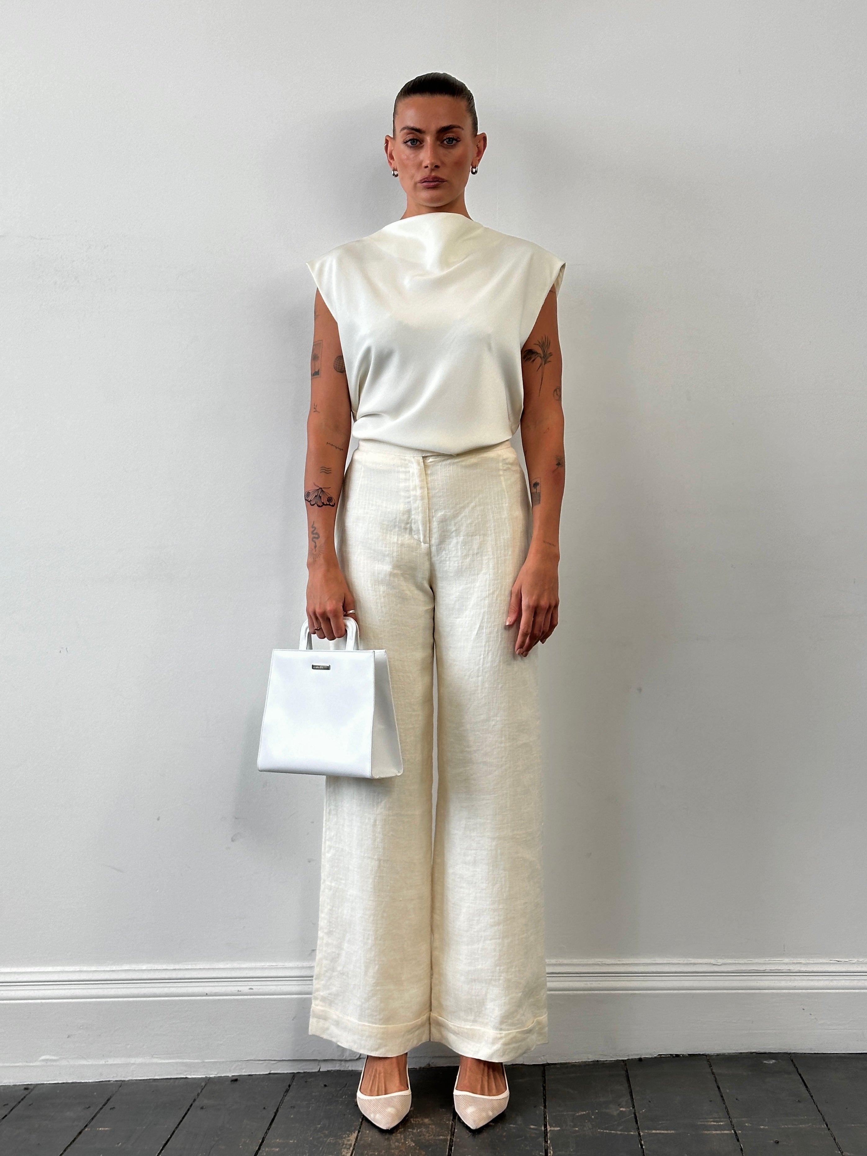 Vintage high waisted wide leg tailored trousers in W26, showing the classic fit and fabric detail.