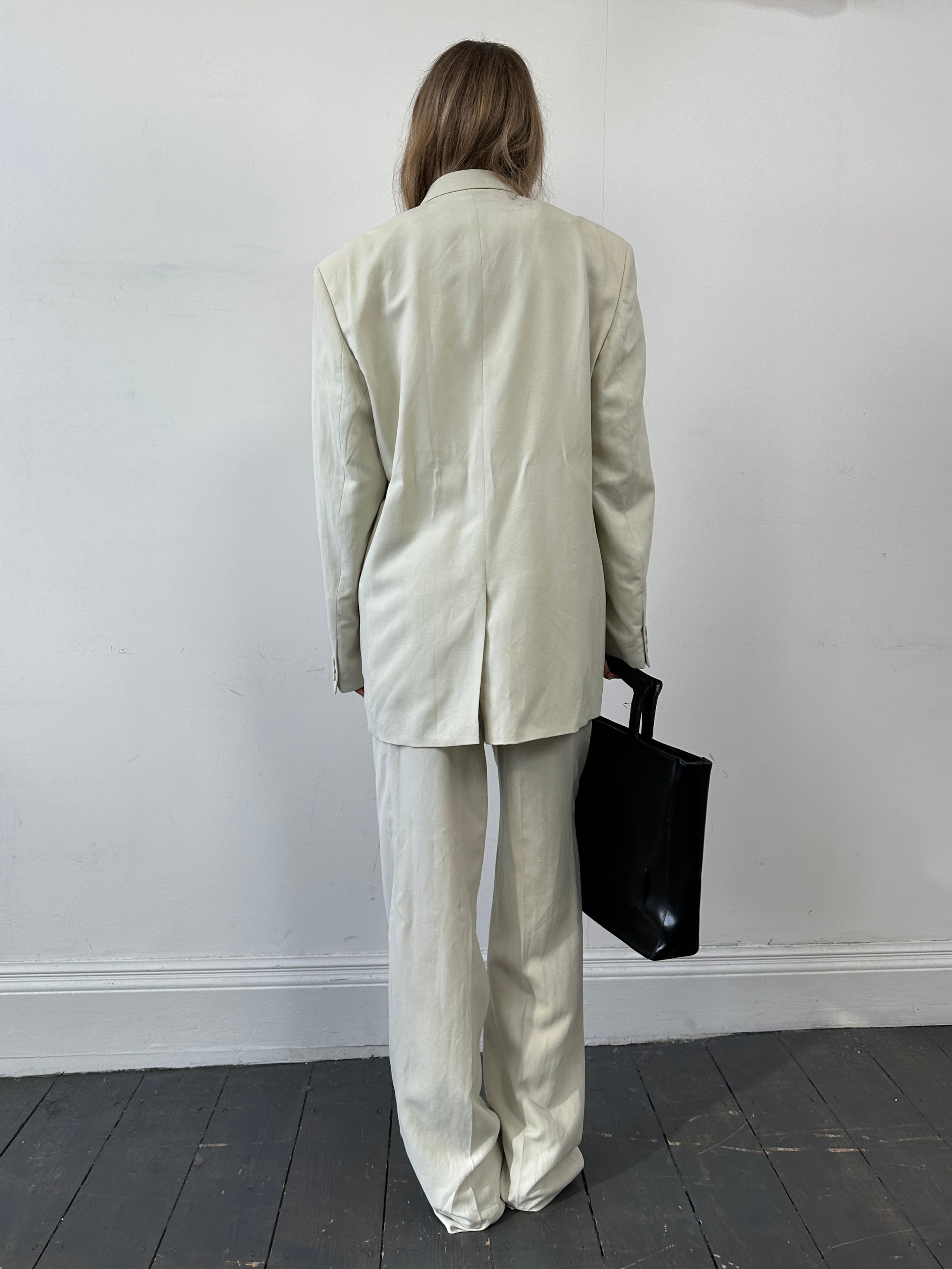 Pierre Cardin linen Tencel jumpsuit in single-breasted design, size 42L/W34, shown on a hanger with a neutral background.