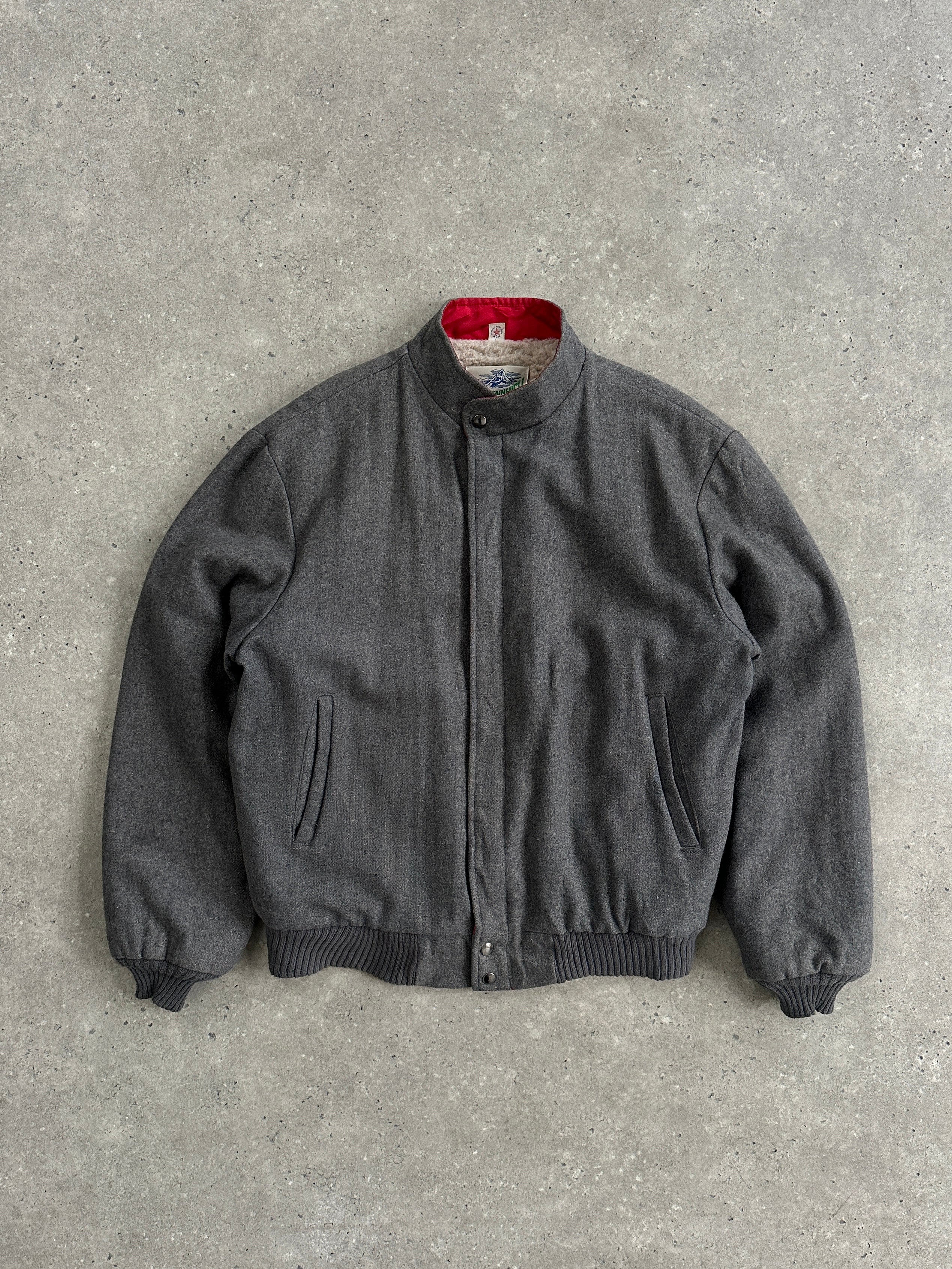 Vintage wool fleece-lined bomber jacket in size L, featuring a classic design with ribbed cuffs and collar, perfect for cold weather.