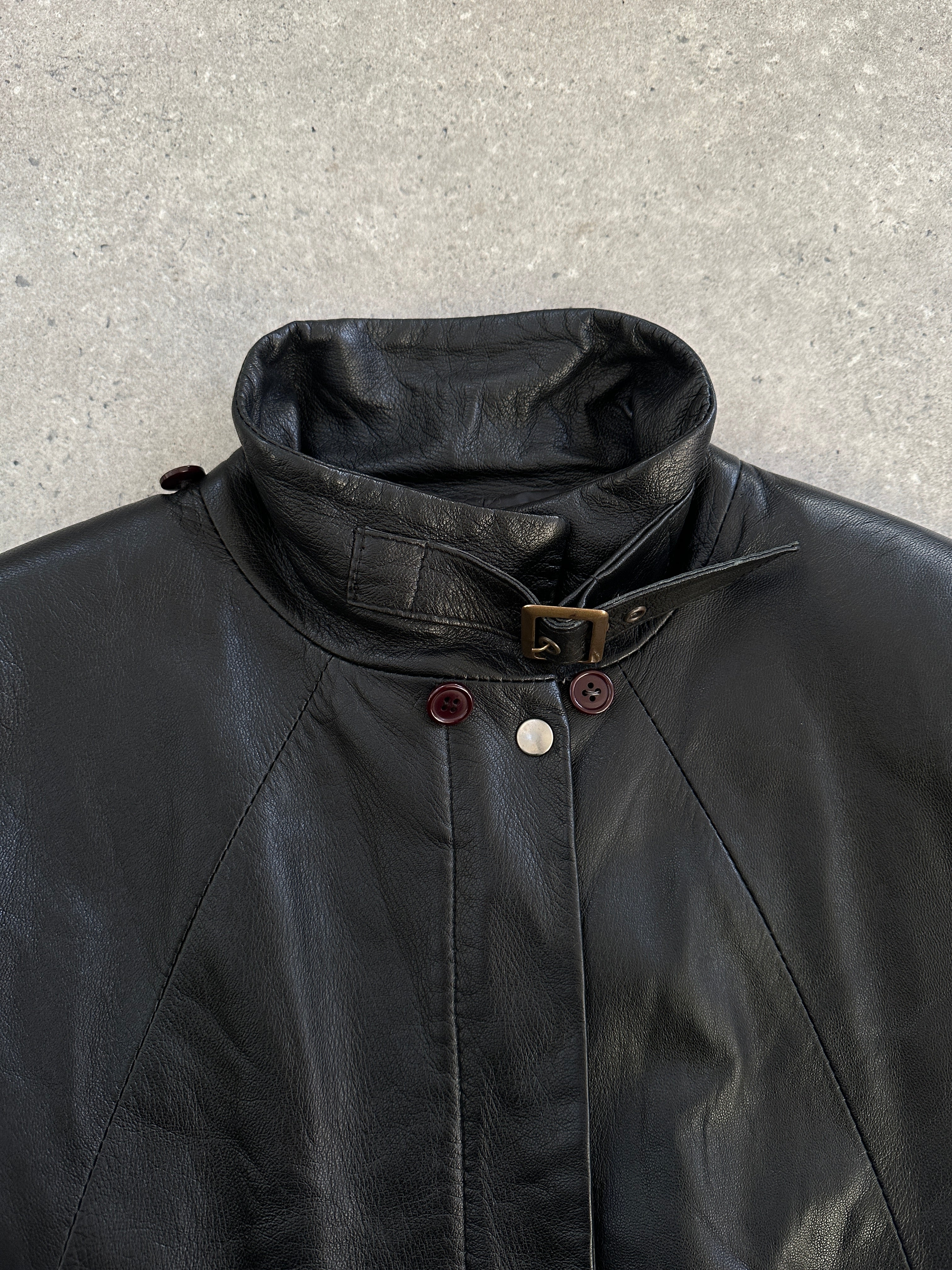 Vintage Italian 1990s high neck leather jacket, size M, featuring classic leather texture and retro design.