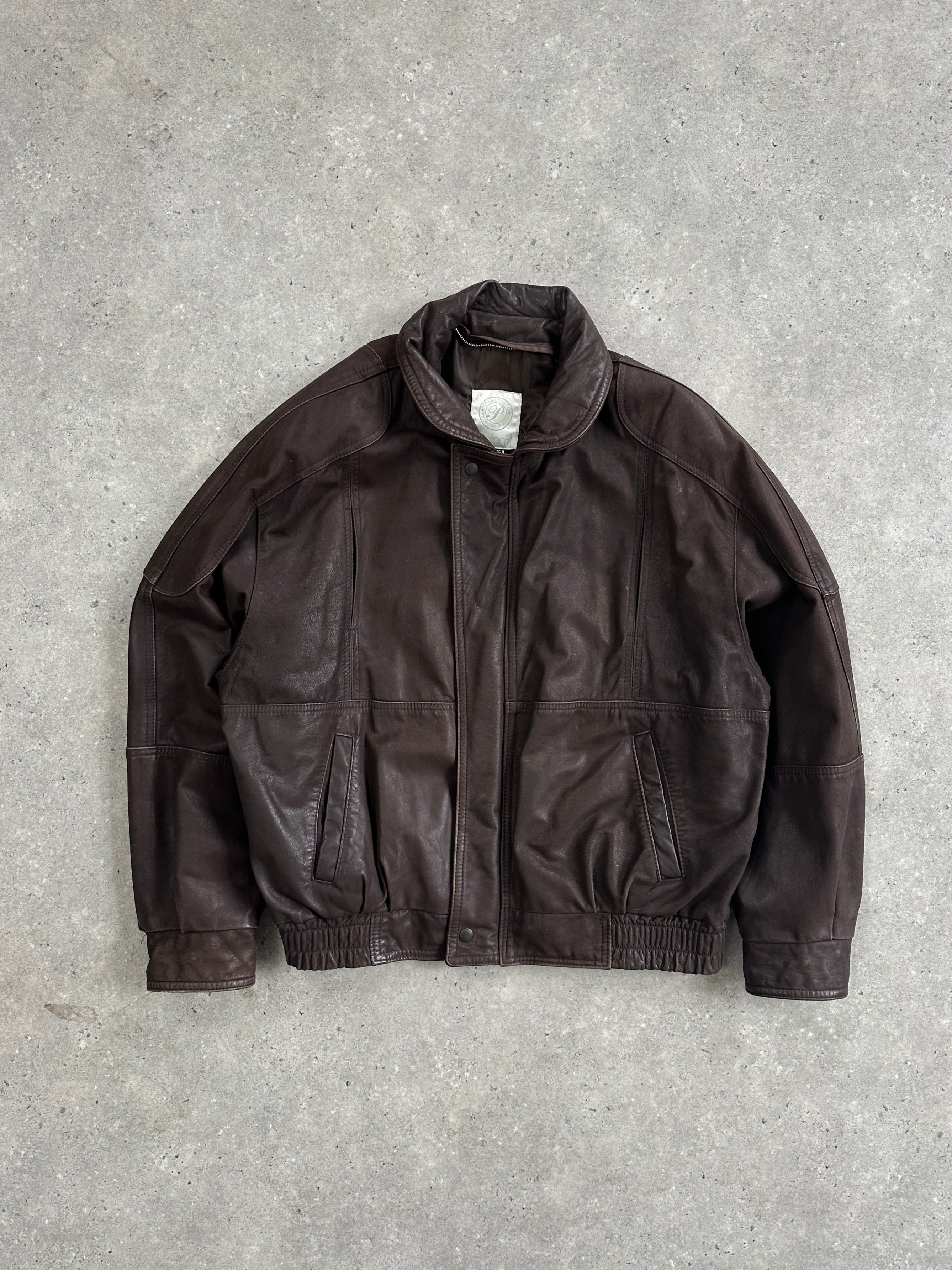 Vintage leather bomber jacket in XL size, featuring classic design with a worn-in look and ribbed cuffs and collar.