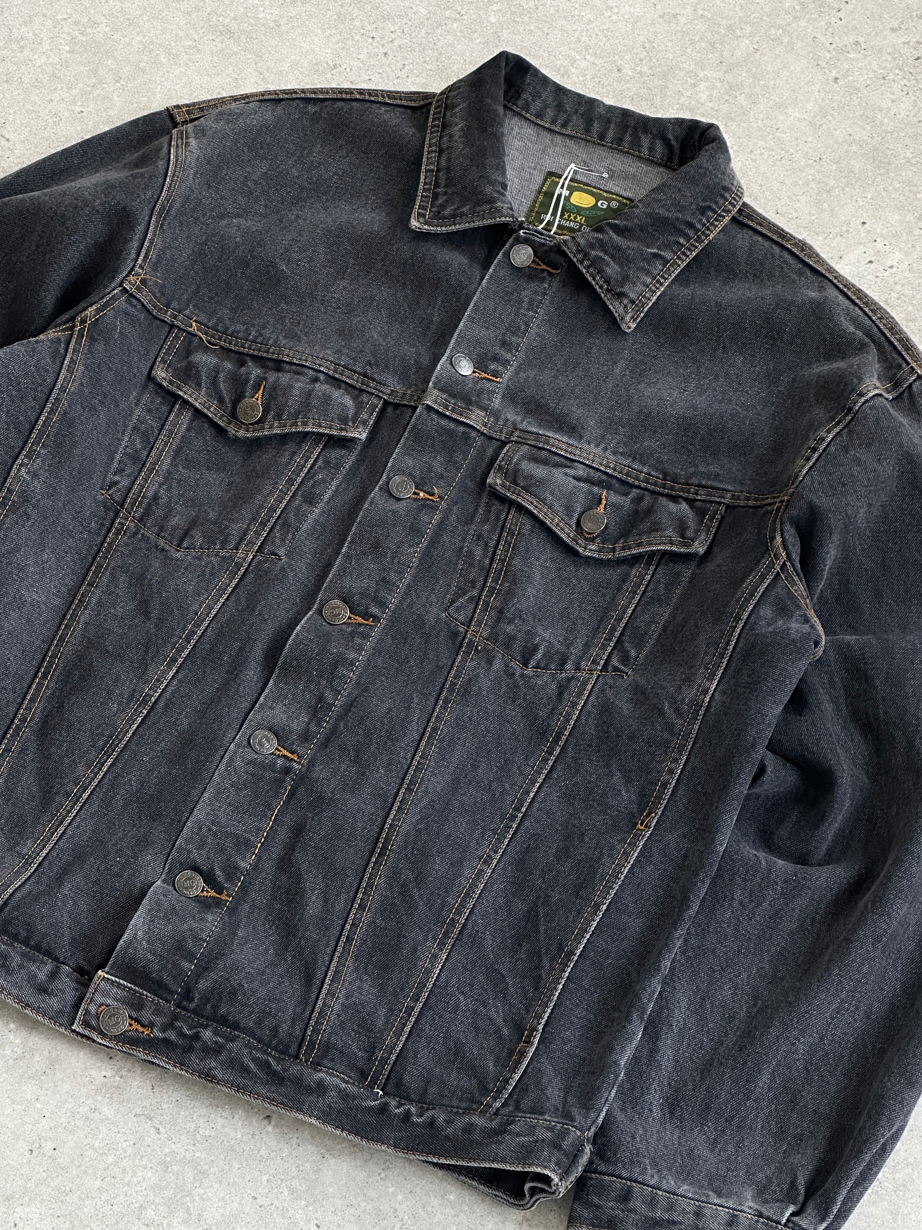 Vintage oversized washed denim jacket in XXL, showing classic distressed denim fabric and button-front design.