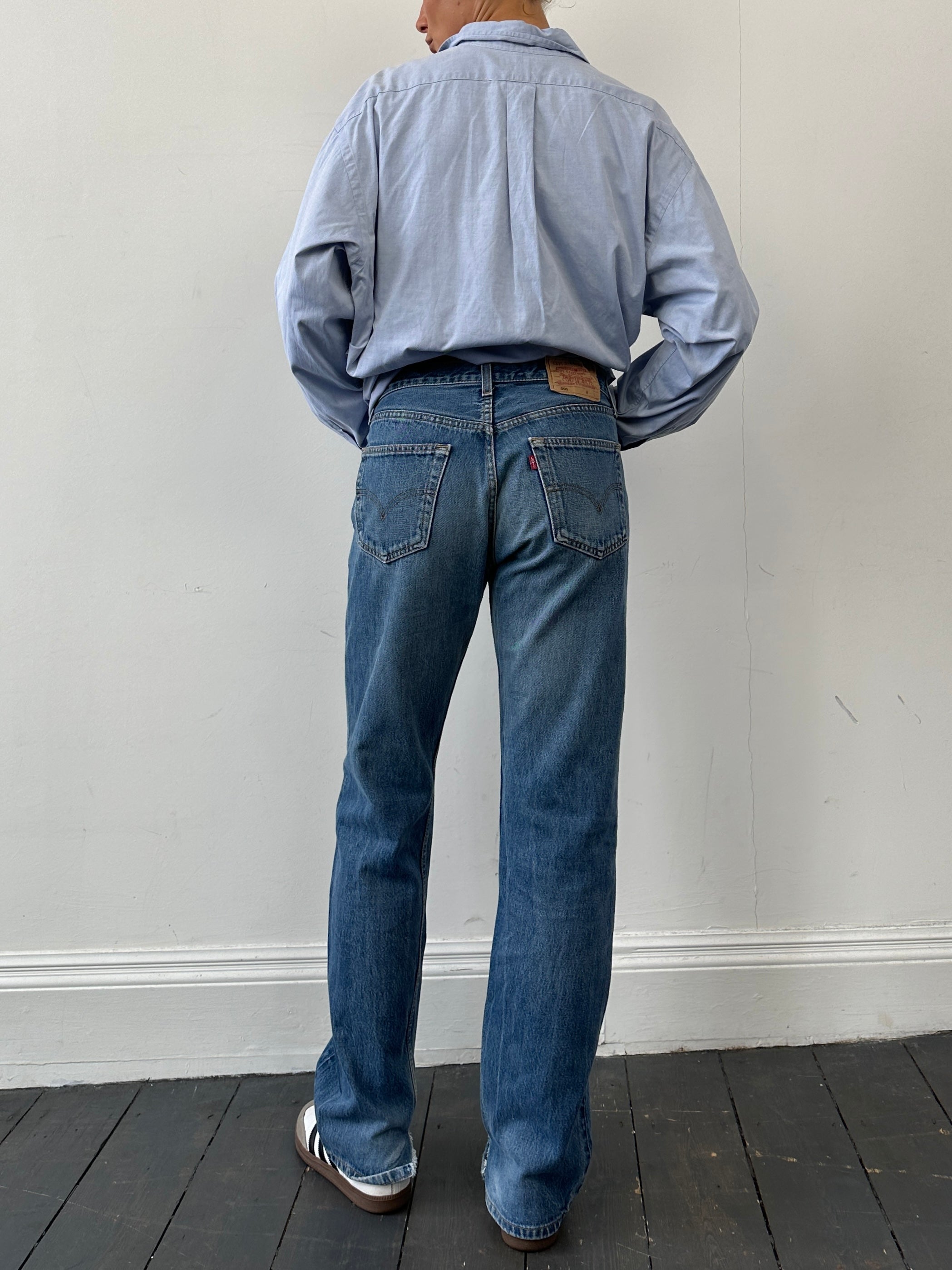 Levi’s 501 Mid Wash Distressed Straight Leg Denim Jeans, W30, showcasing classic fit with distressed details and five-pocket design.