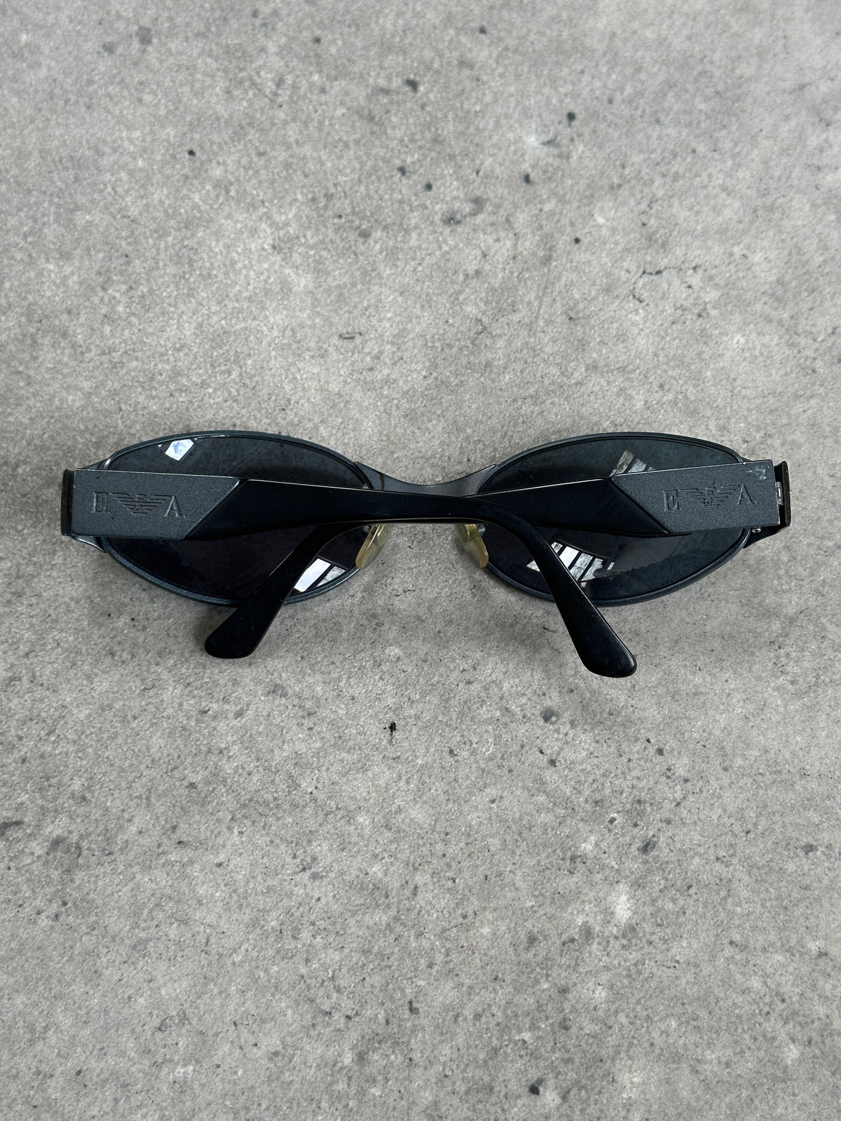 Emporio Armani 1990s oval logo sunglasses with dark tinted lenses and black frame, stylish and iconic designer eyewear.