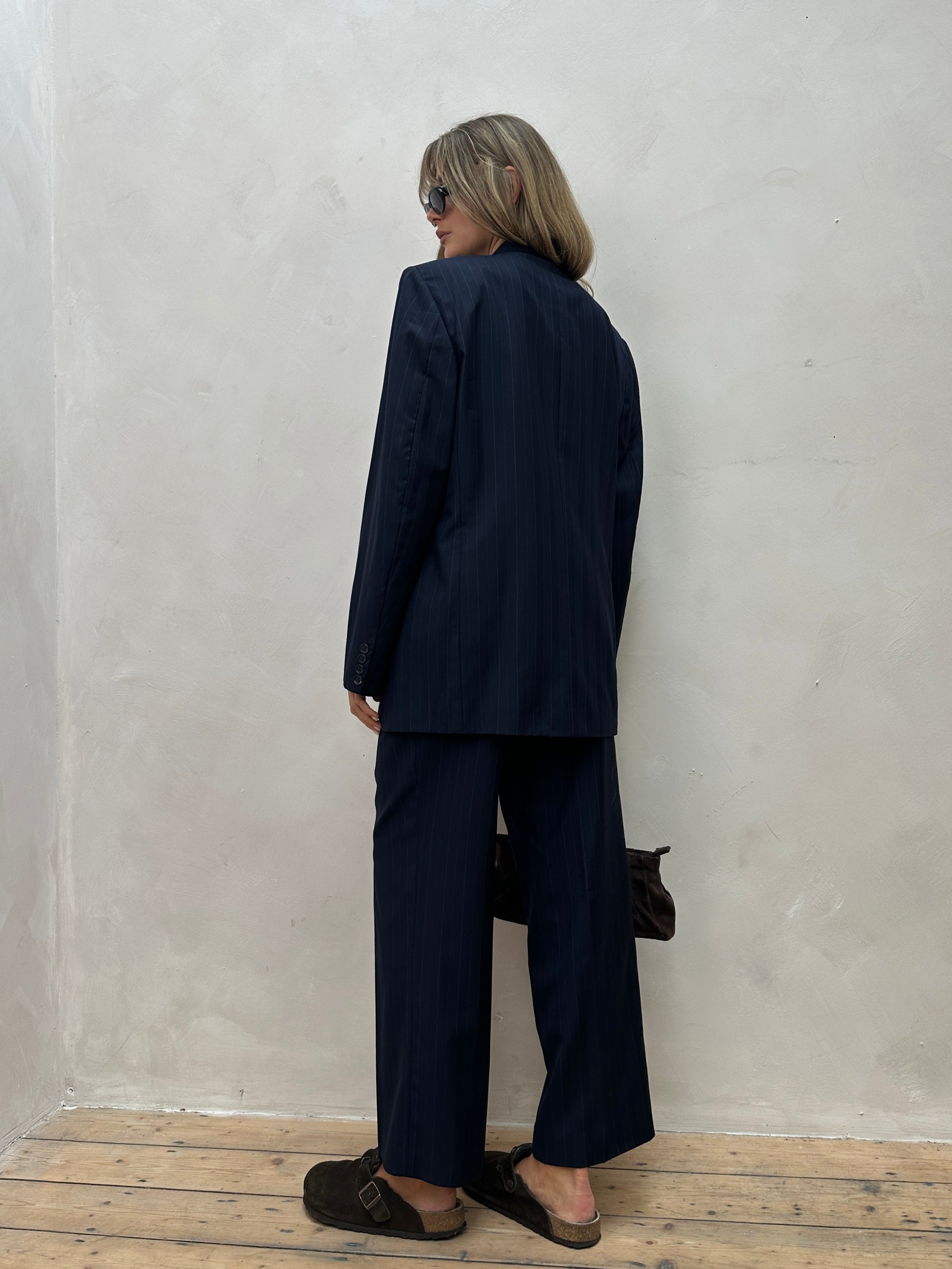 Christian Dior pinstripe pure wool double-breasted jumpsuit in size 44R/W34, showcasing tailored design and classic style.