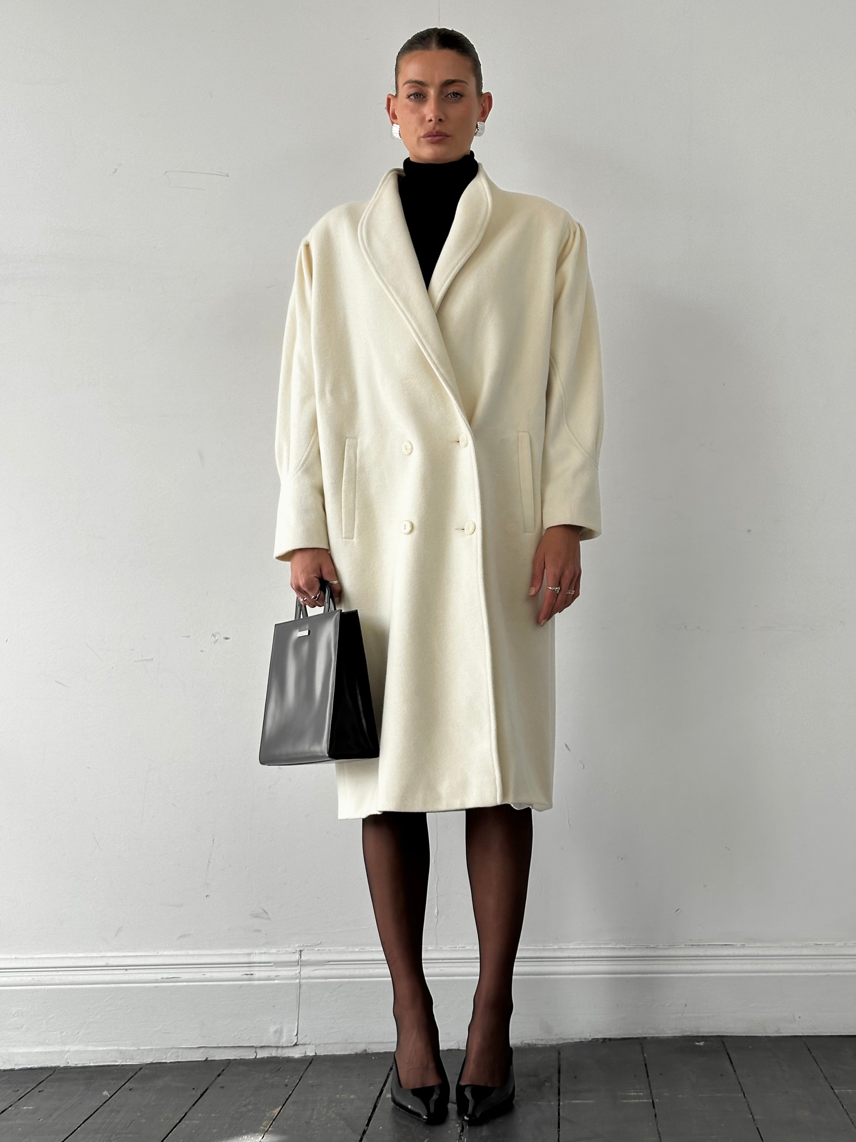 Vintage pure wool double-breasted coat in size L/XL, featuring classic design and textured fabric for a timeless look.