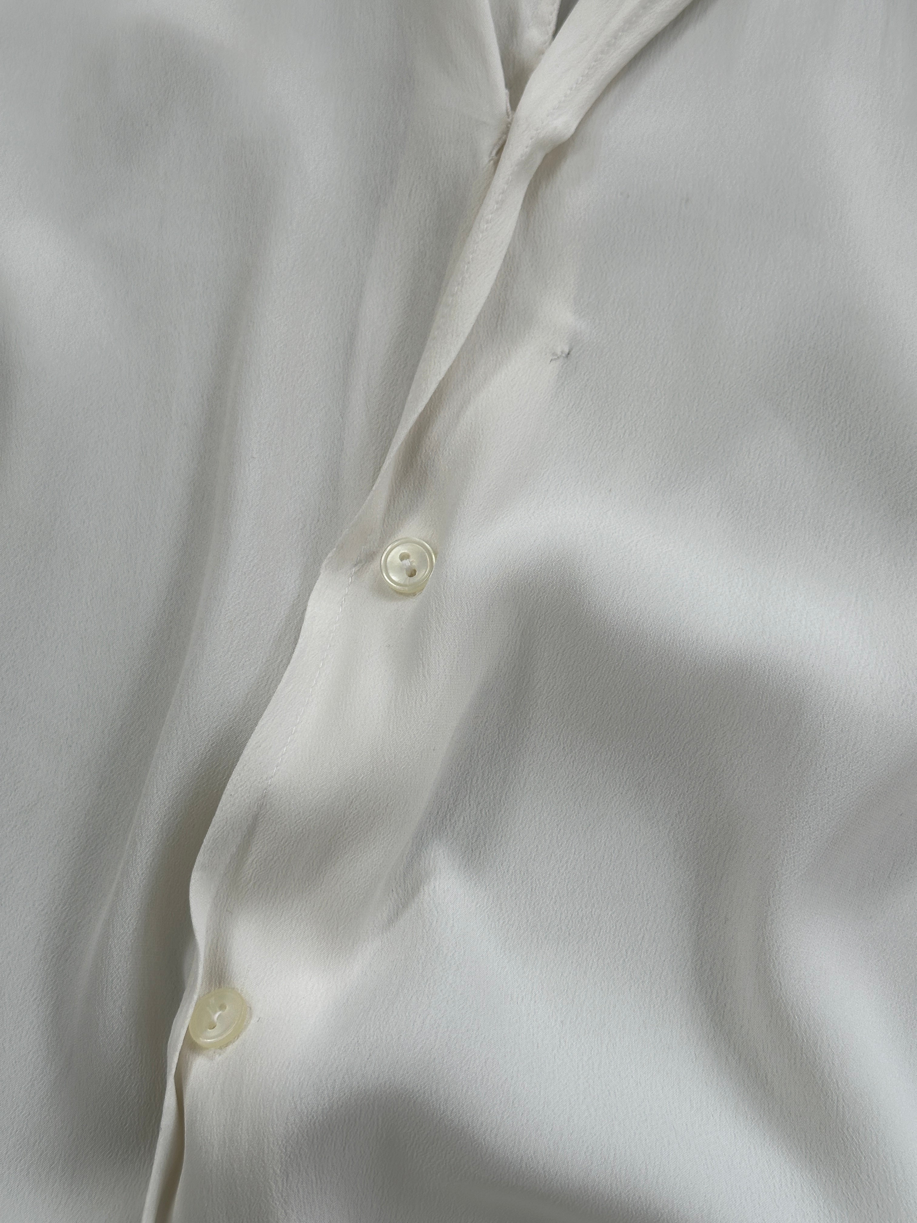 Vintage silk flowy shirt in size L featuring a relaxed fit and elegant drape, stylishly displayed on a hanger.